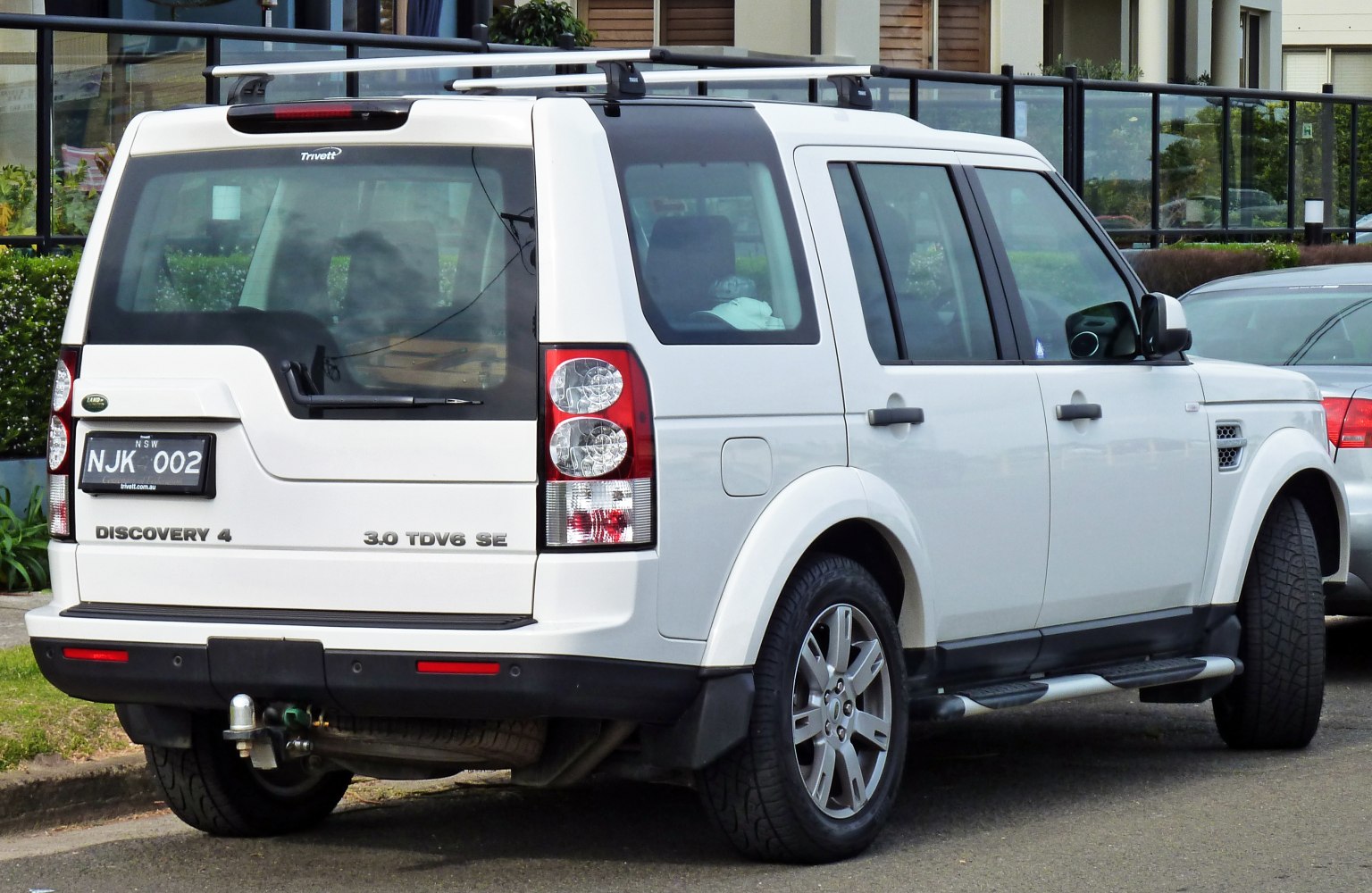 Rear view of SUV with towing hitch and roof rails