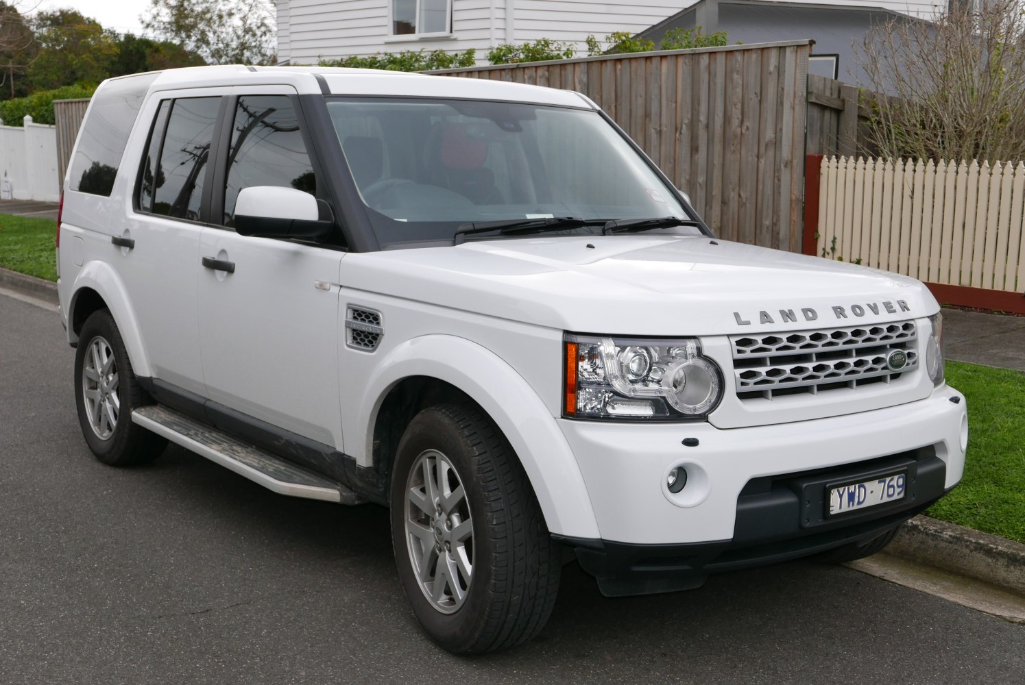 White SUV with distinctive front grille, headlights, and side profile