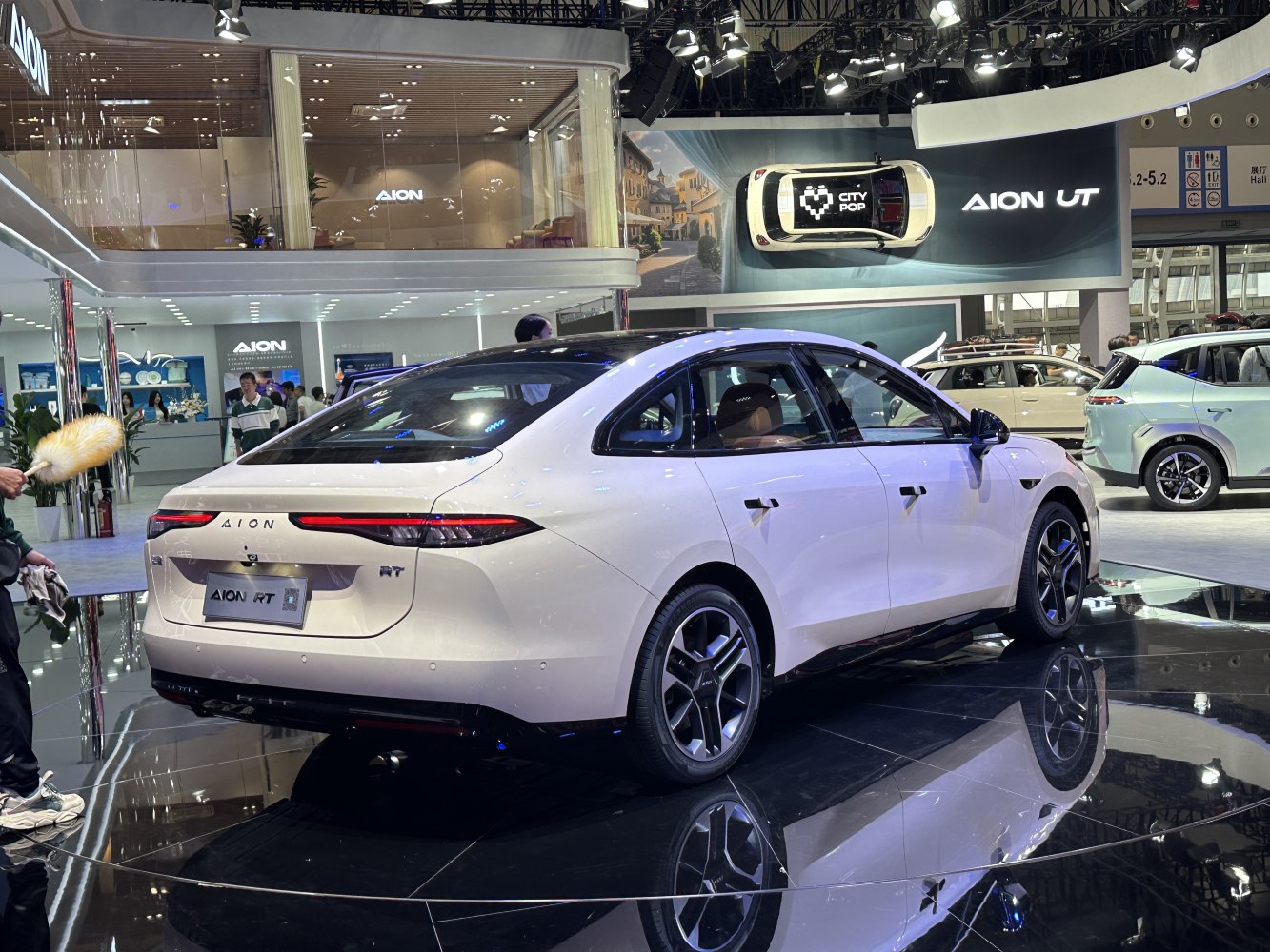 Rear three-quarter view of modern electric sedan with sleek taillights and alloy wheels