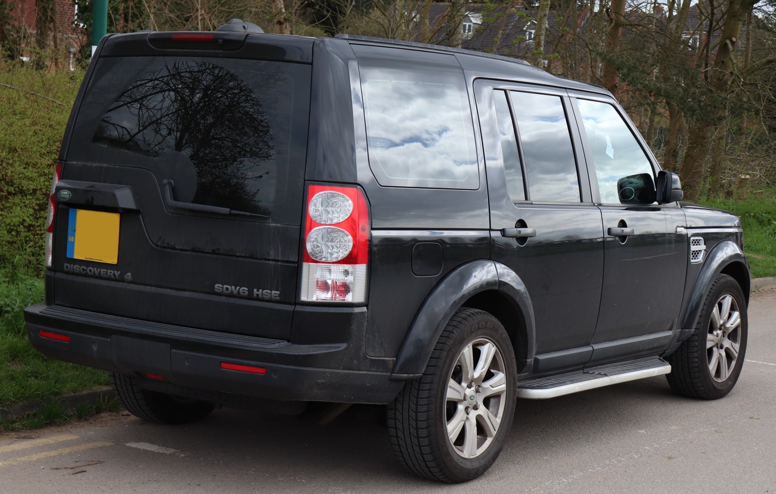 Rear side view of black SUV showing taillights and rugged design.