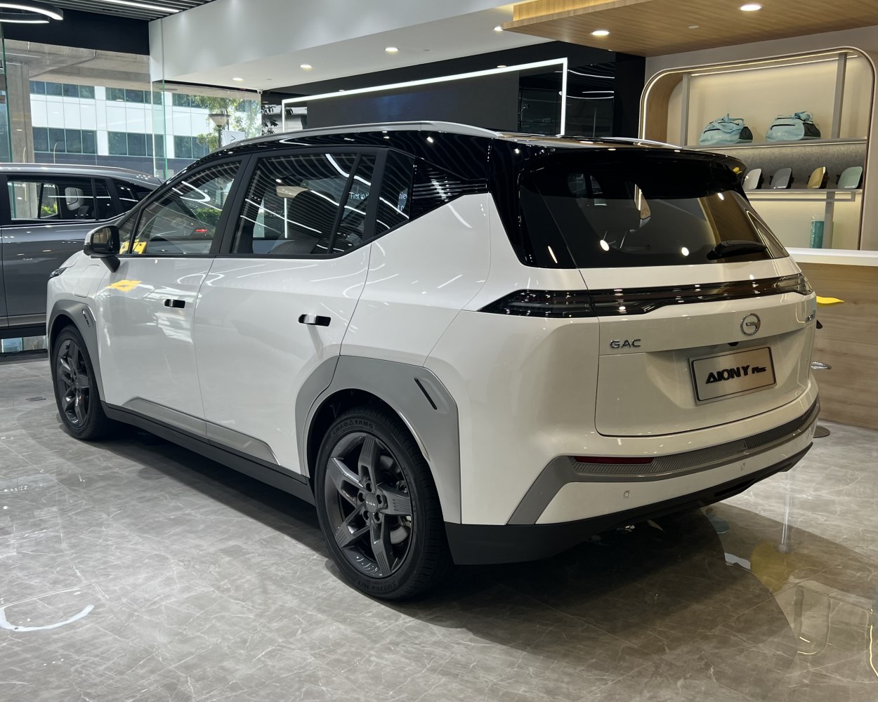Rear and side profile of a modern electric SUV with black roof and alloy wheels