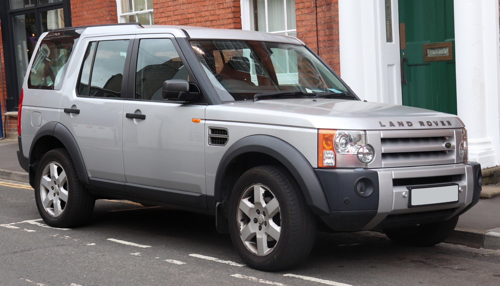 Silver SUV with large headlights and robust front grille