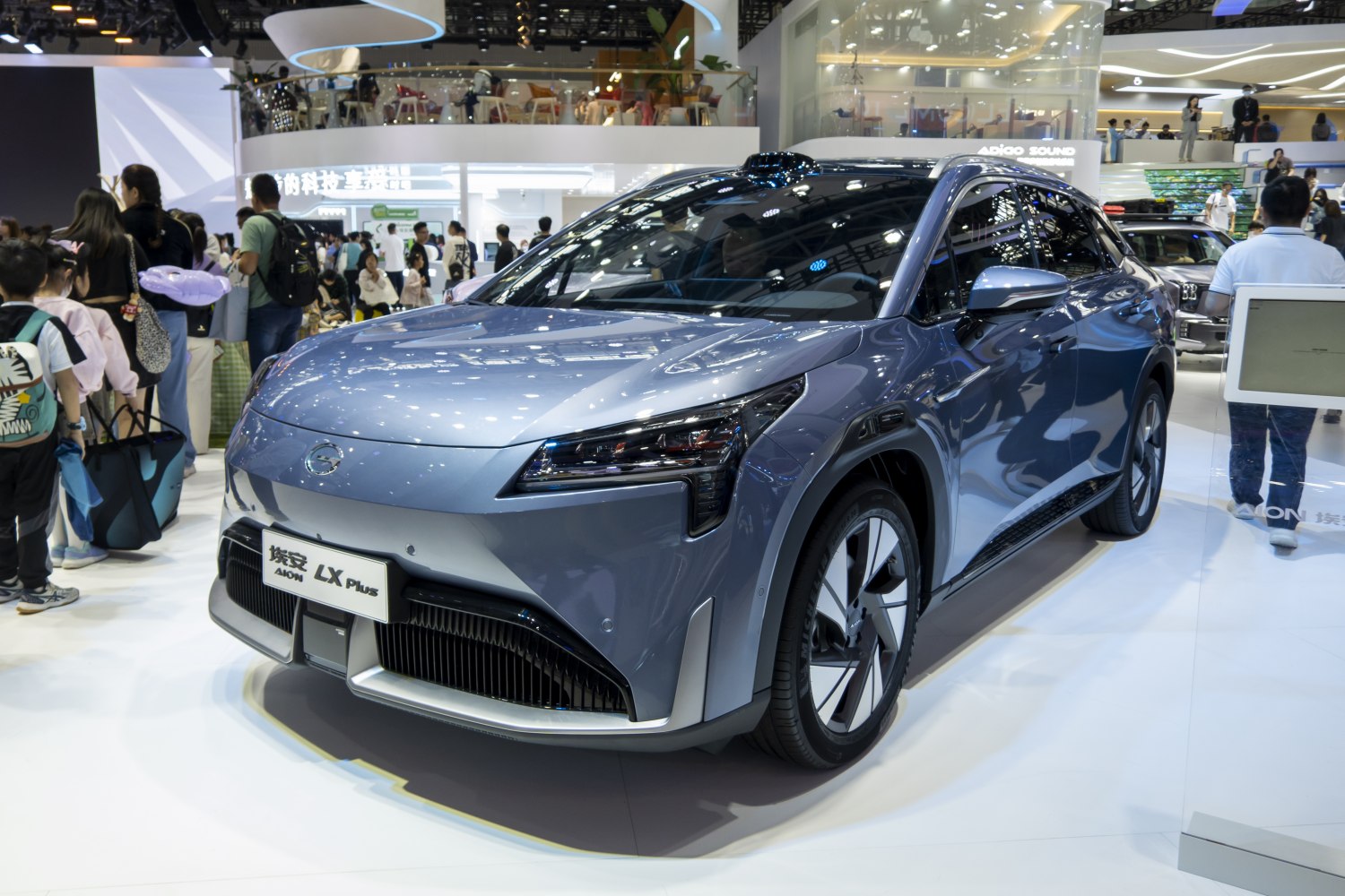 Front view and alloy wheels of an electric SUV at a car show