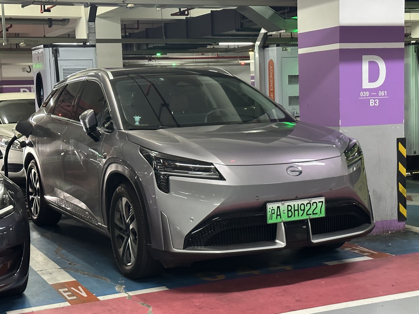 Electric SUV front view charging with sleek aerodynamic design and modern headlights.