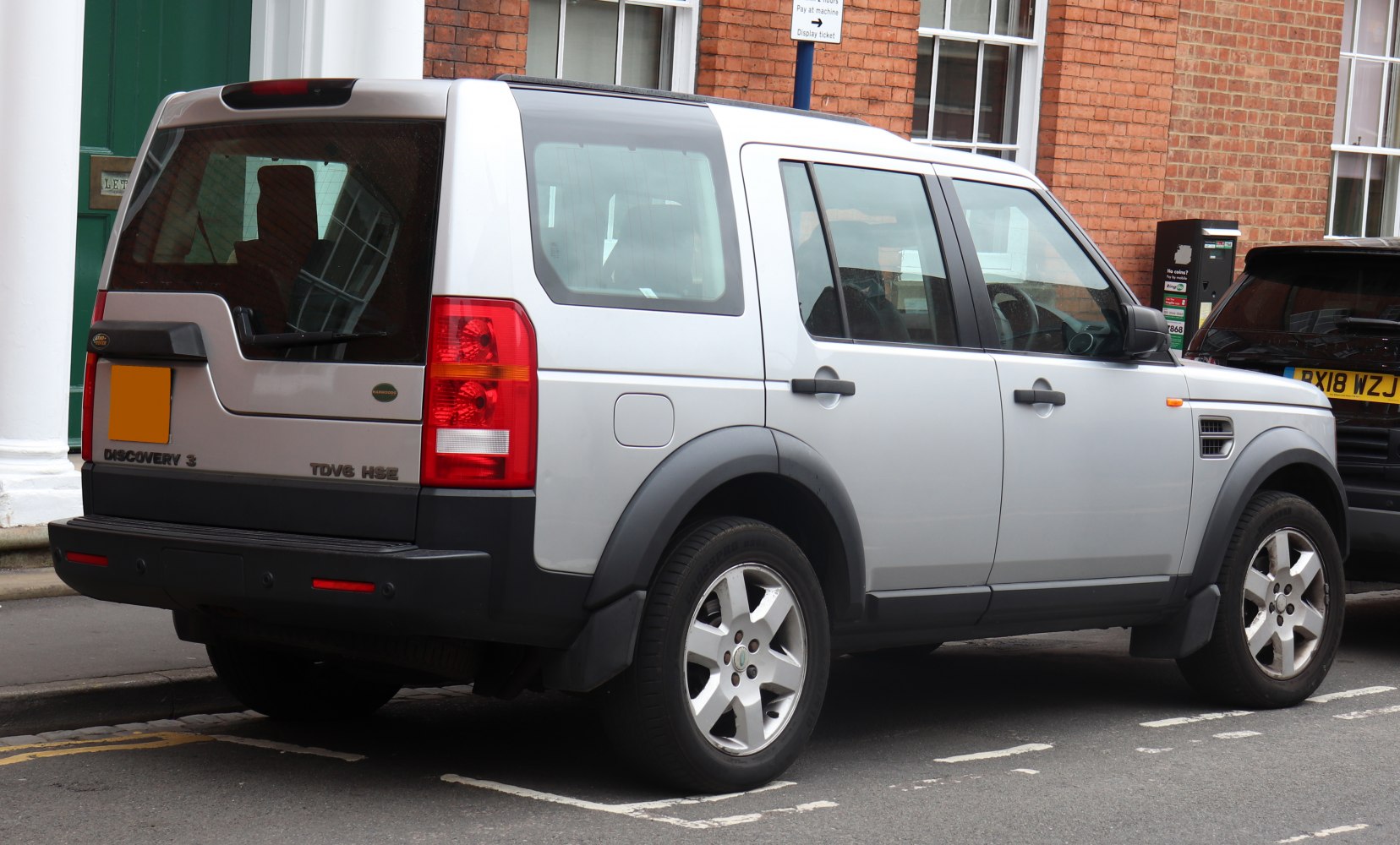 Rear and side profile with distinctive taillights on boxy SUV