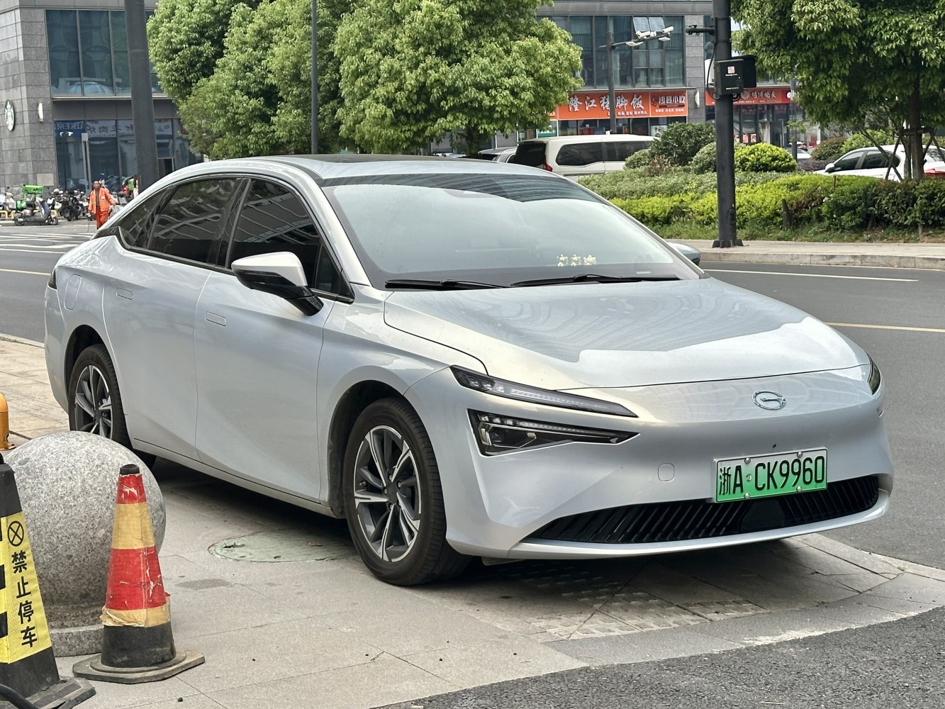 Silver electric sedan with sharp LED front lights and aerodynamic body