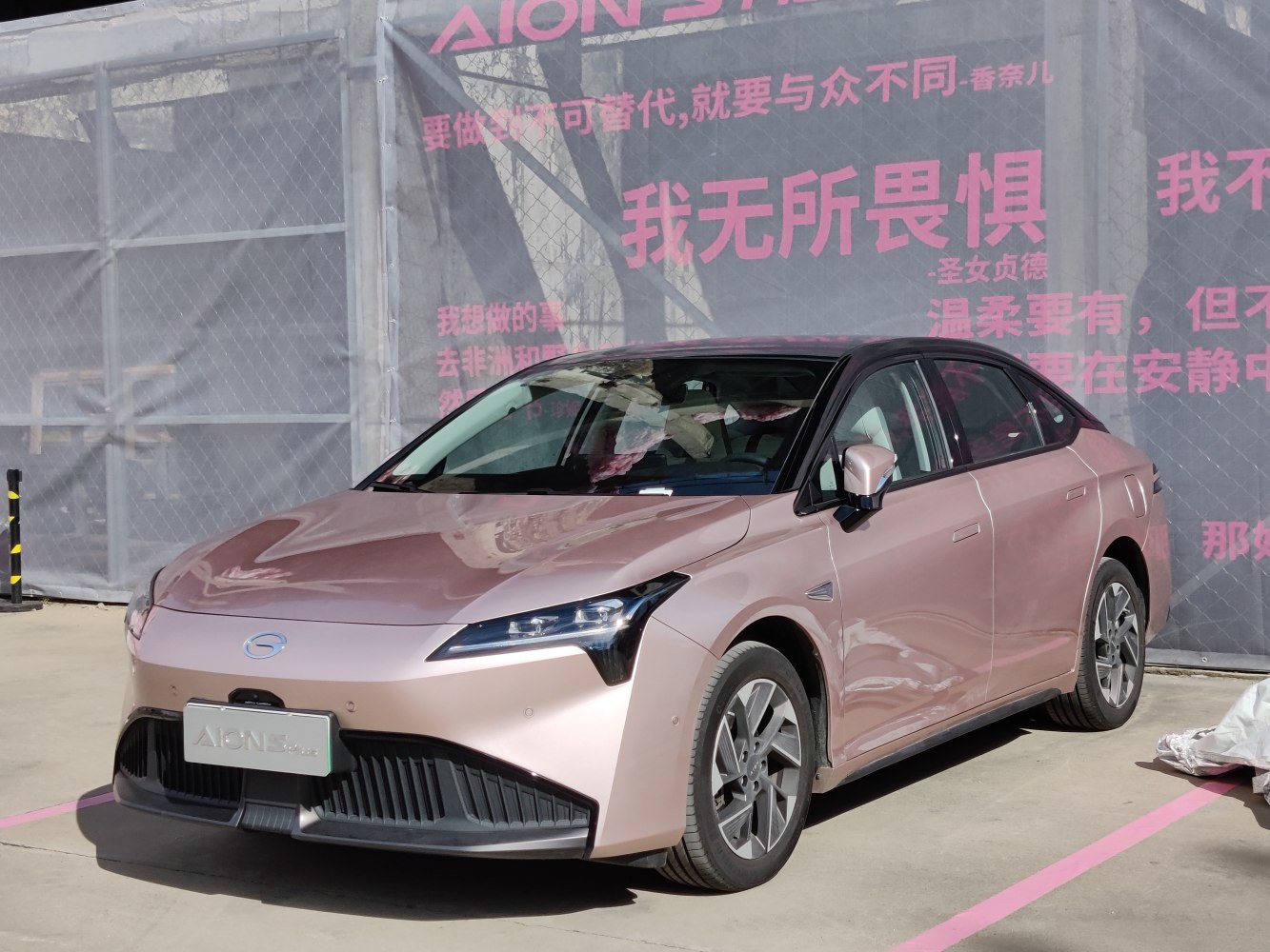Front view with sharp headlights and aerodynamic design of an electric sedan