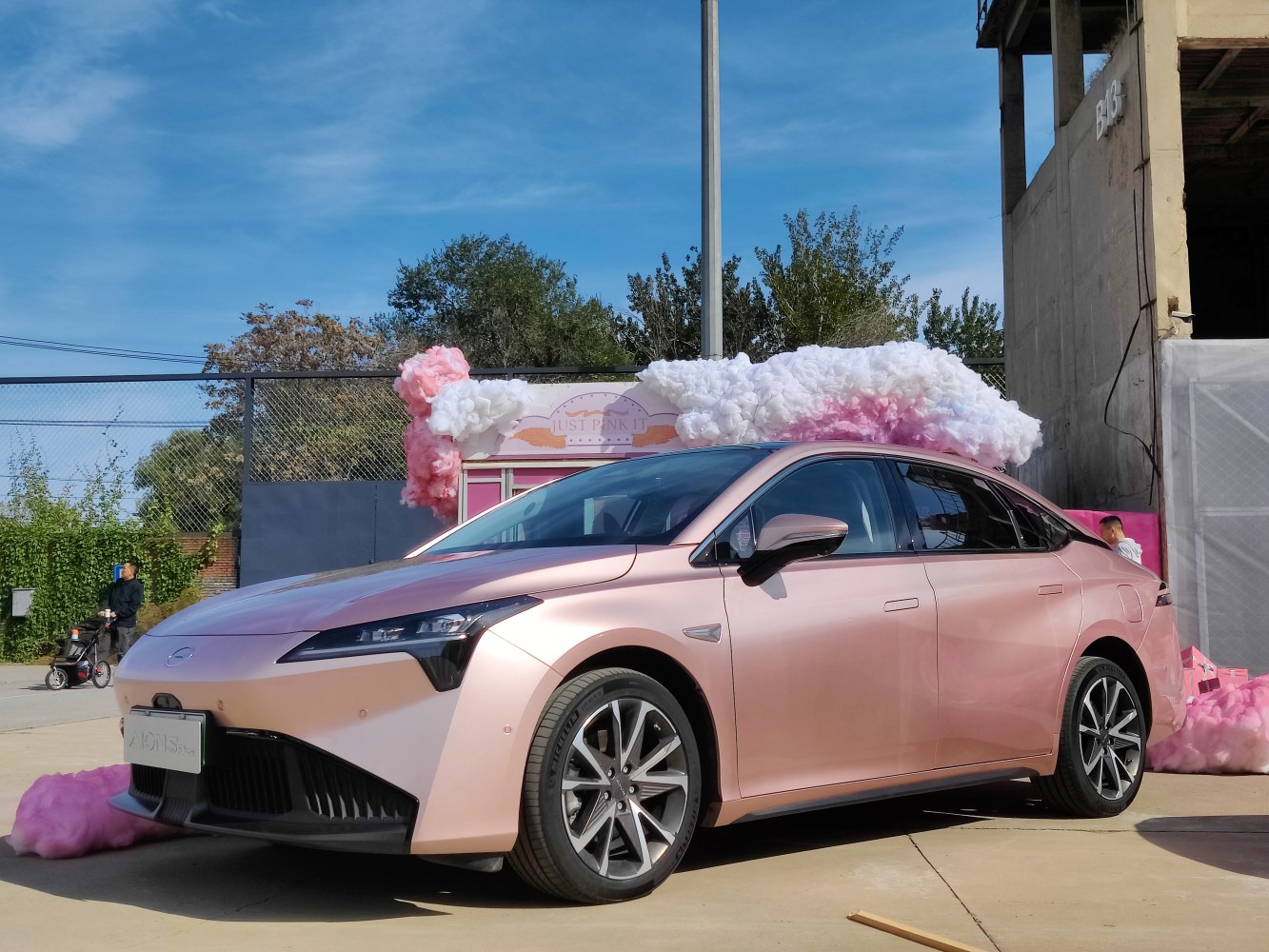 Rose gold electric sedan with LED headlights and alloy wheels