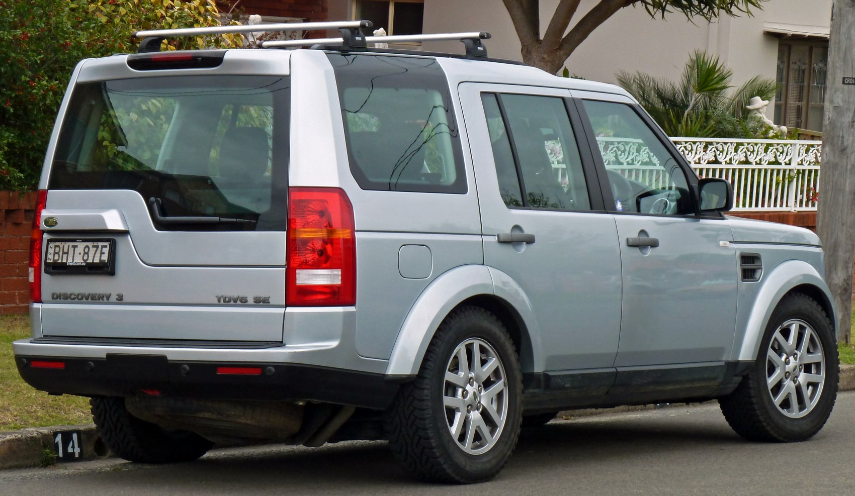 Rear and side view of silver SUV with roof rails and alloy wheels