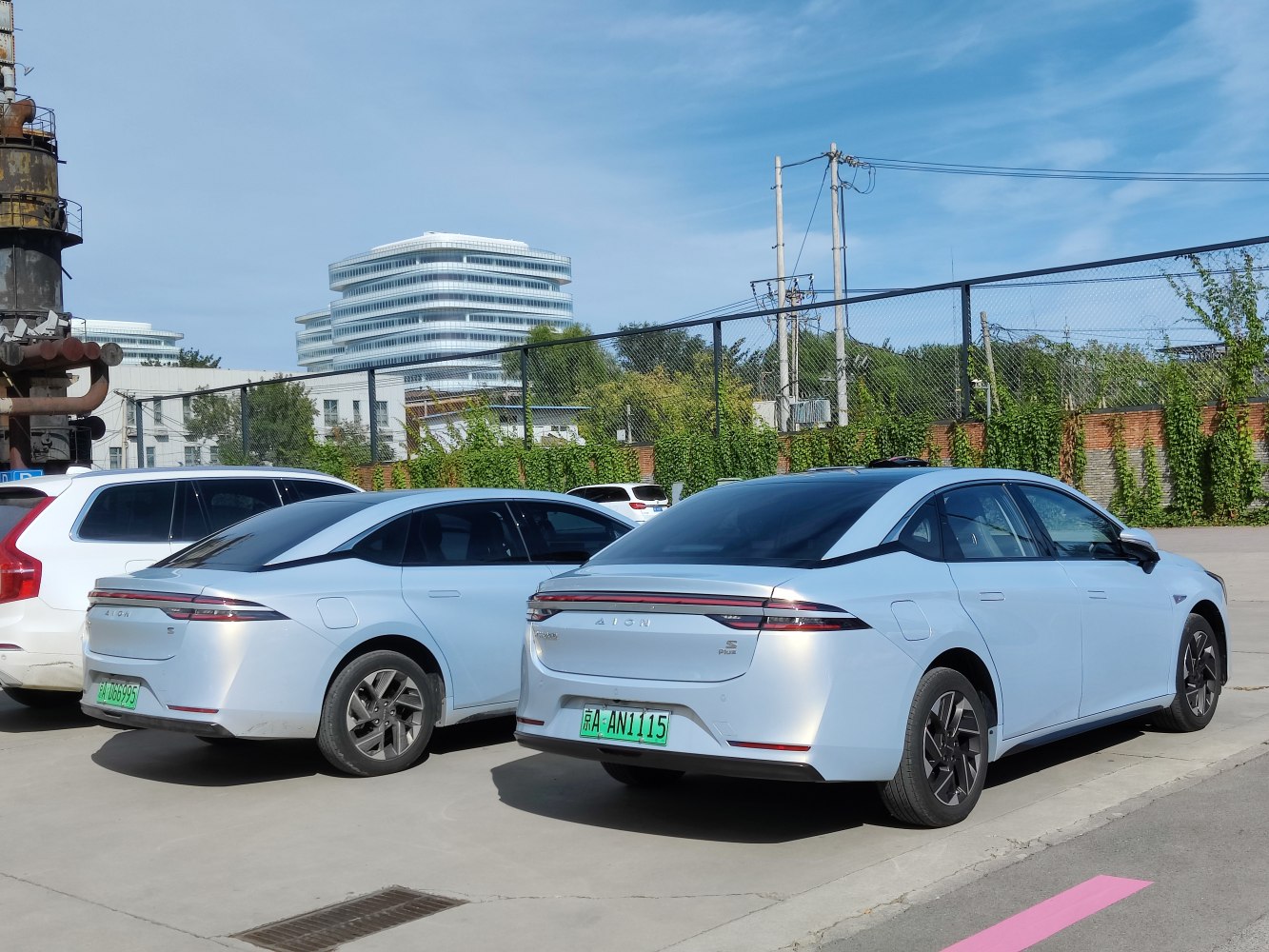 Rear view of two electric sedans with sleek aerodynamic tail lights.