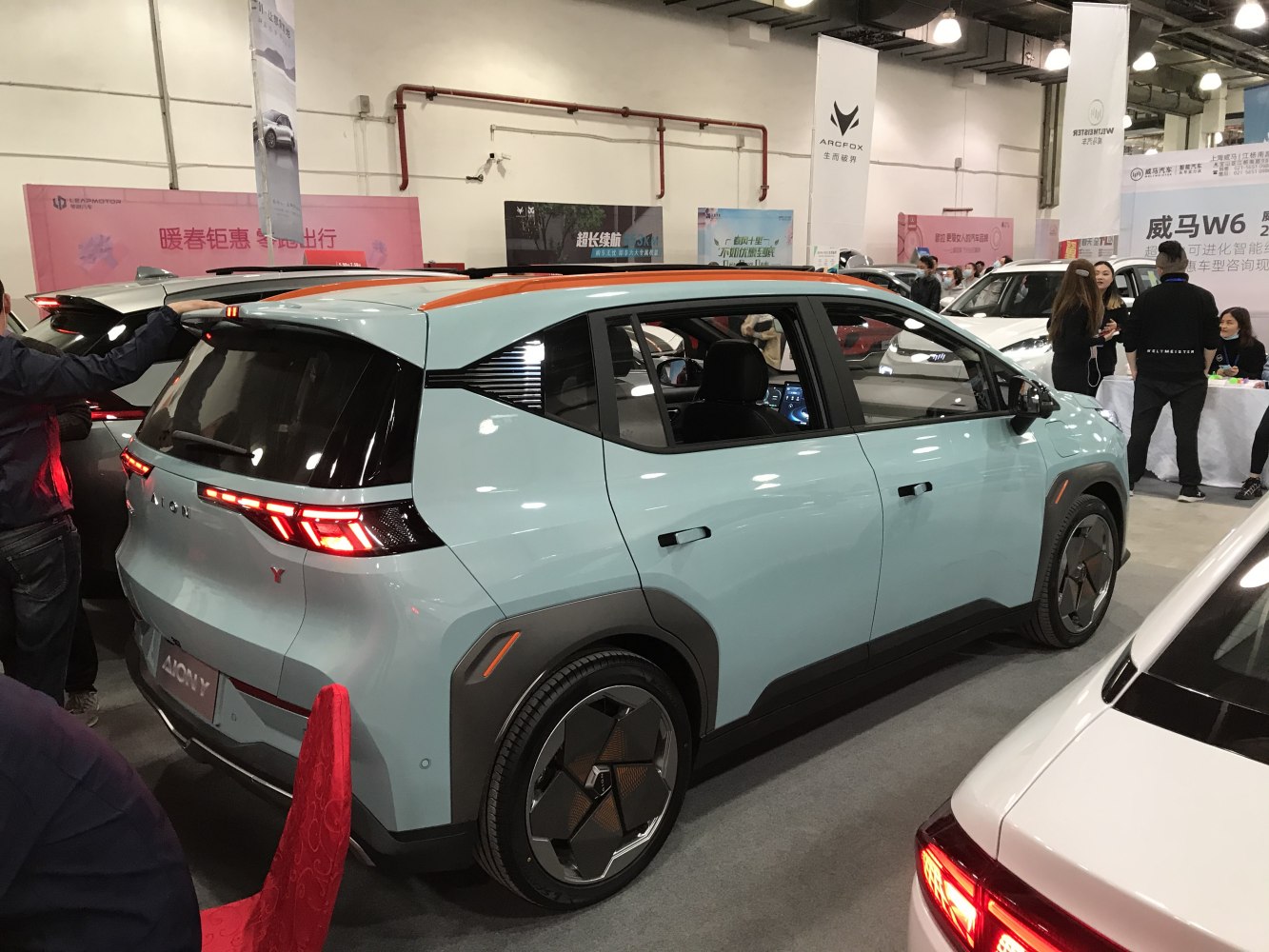 Angular LED rear lights and futuristic wheel design on electric compact SUV.