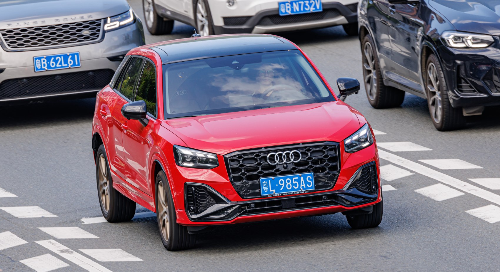 Red compact SUV with sporty front grille and LED headlights