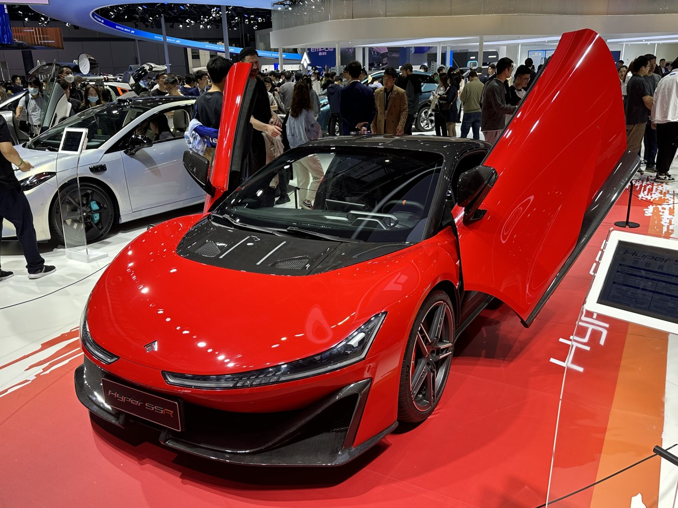 Red hypercar with butterfly doors and carbon fiber hood