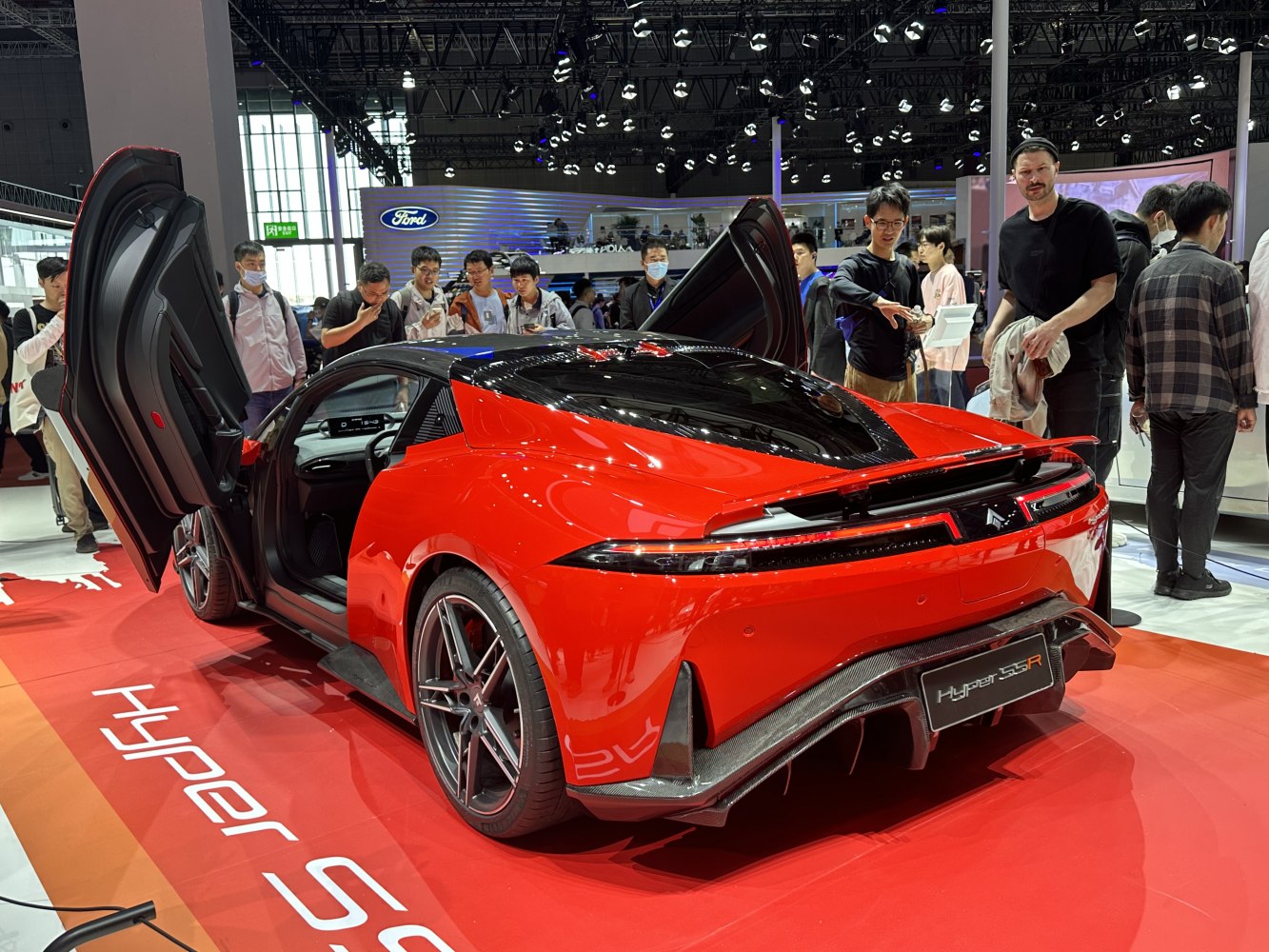 Red sports coupe with butterfly doors and aerodynamic rear