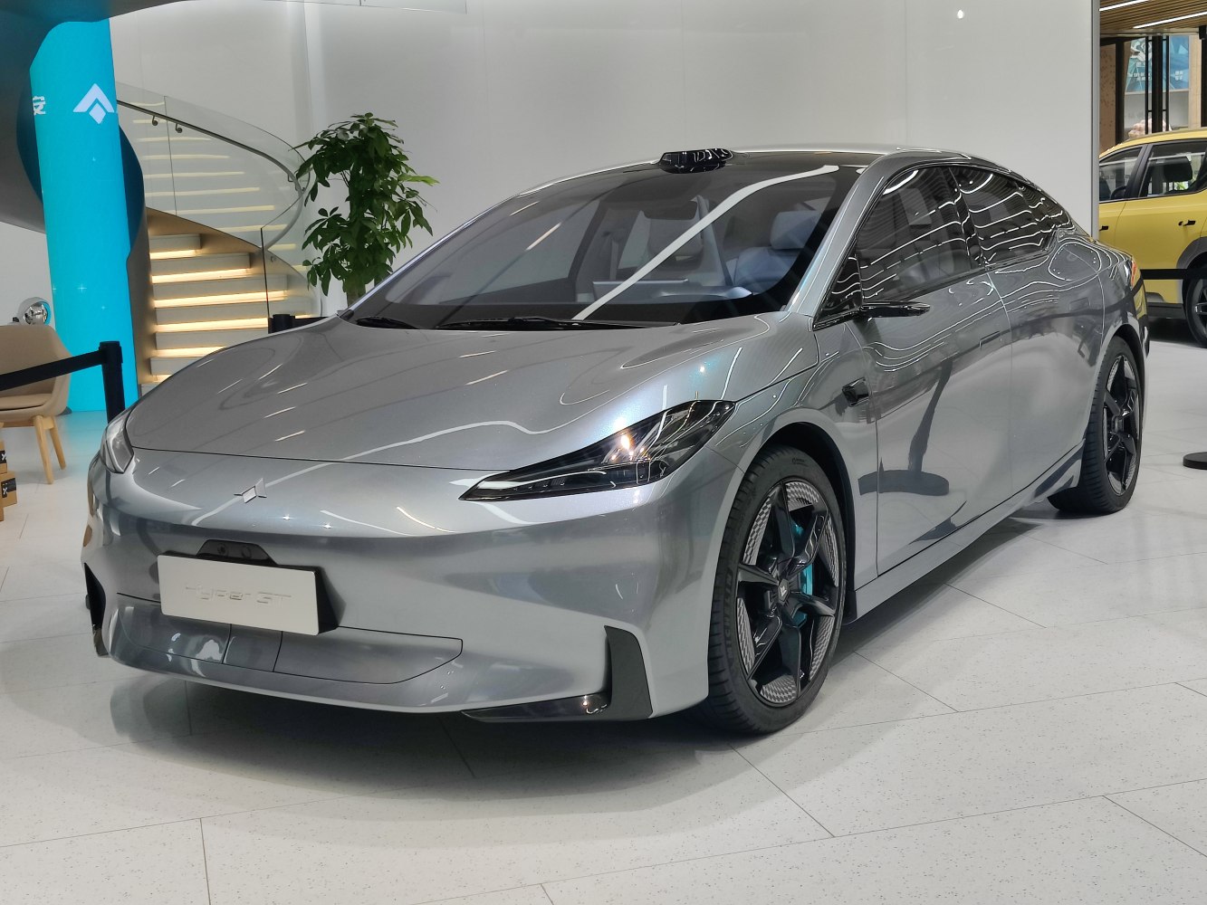 Sleek silver electric sedan with aerodynamic body and futuristic headlights