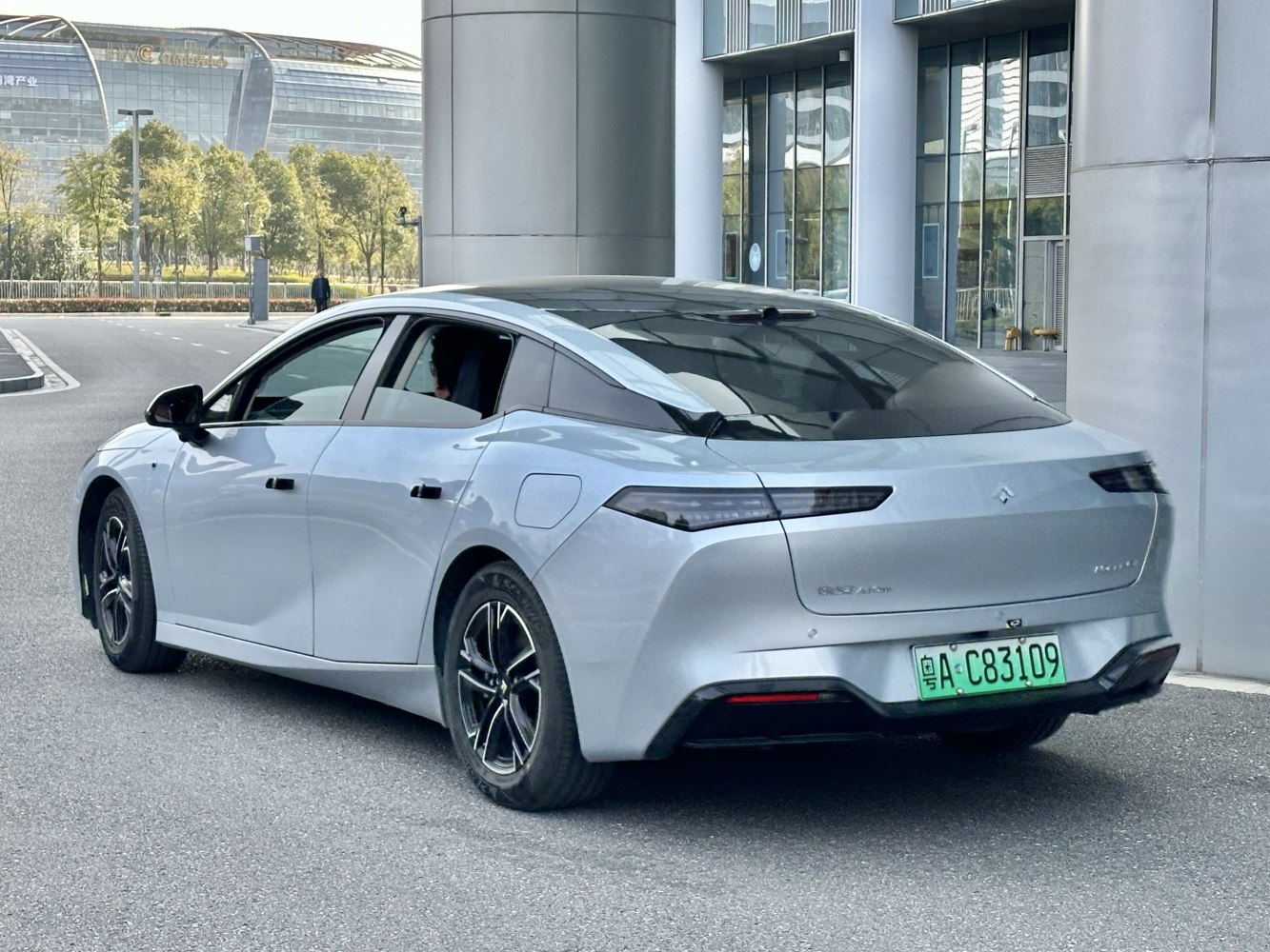 Rear-side profile with sleek taillights and aerodynamic sedan shape