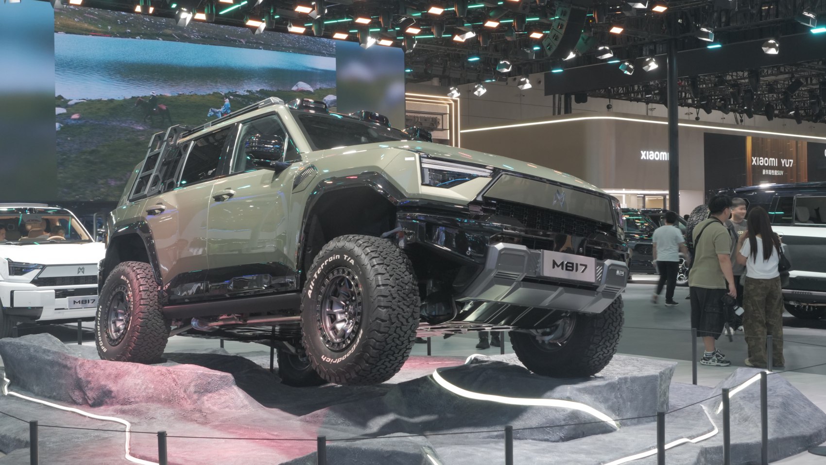 Rugged SUV with all-terrain tires on rocky display.