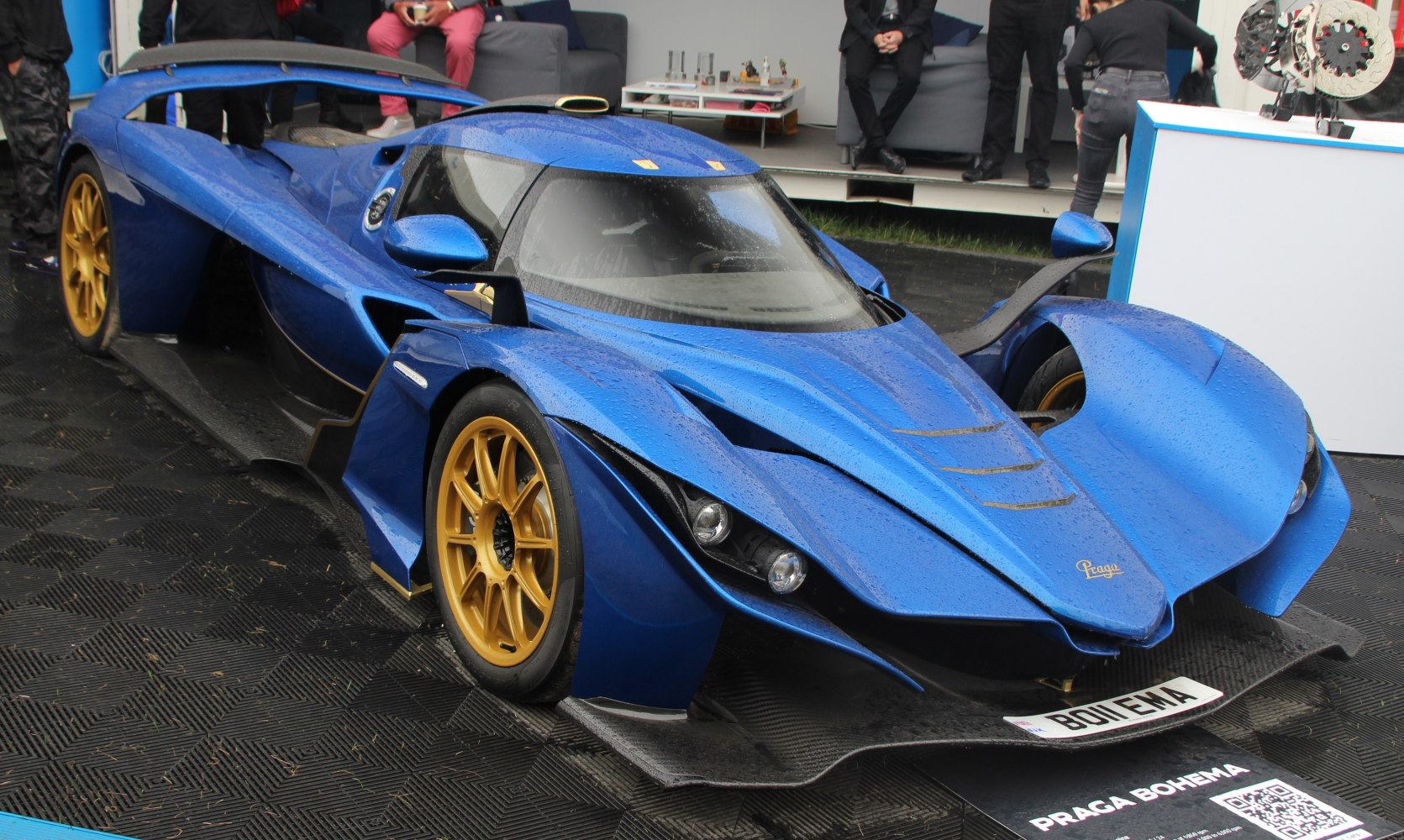 Blue aerodynamic hypercar with gold wheels and aggressive front design
