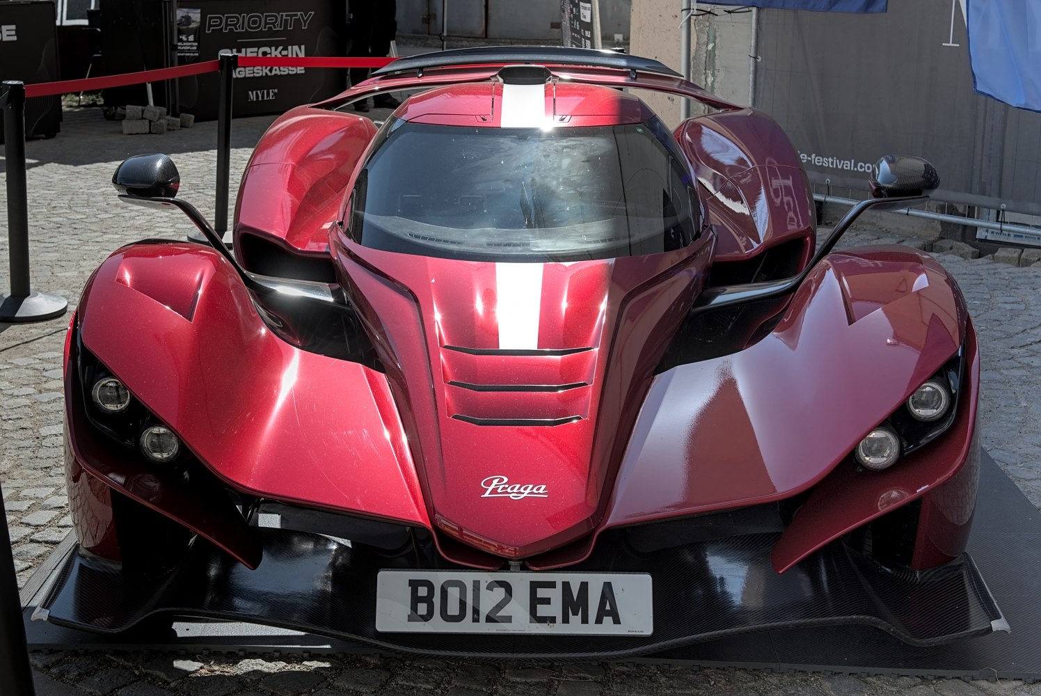 Aerodynamic red hypercar front with splitter and LED headlights