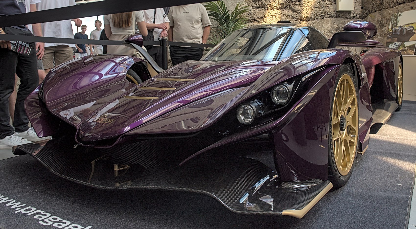 Aerodynamic front with dual headlights and carbon fiber splitter.