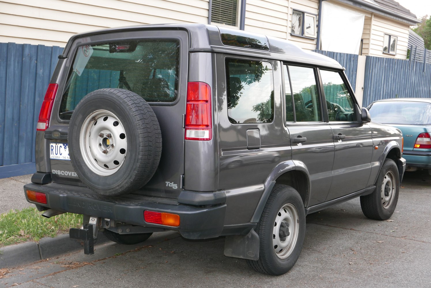 Grey SUV rear with spare tire and tow hitch