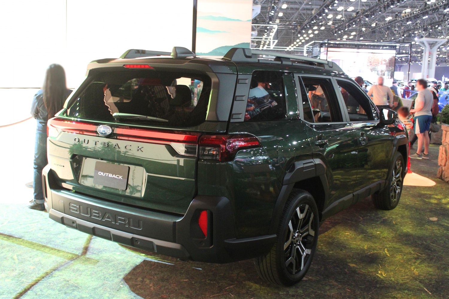 Rear and side view of an SUV with rugged design, modern taillights, and roof rails