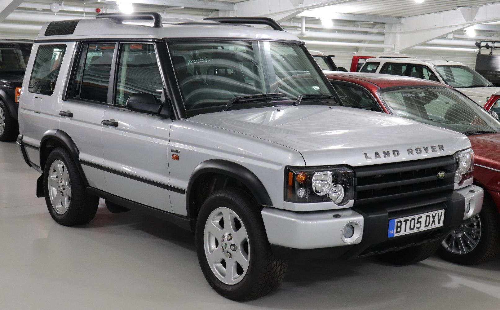 Silver SUV with roof rails and black bumpers