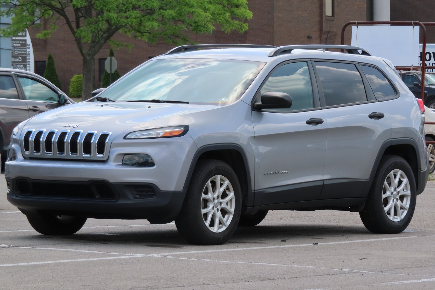 Silver SUV with unique front grille and roof rails