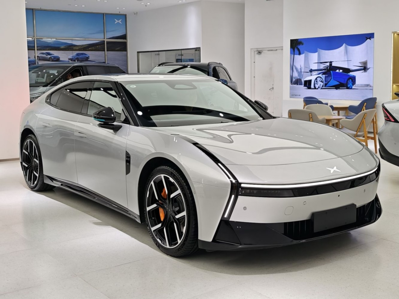 Sleek electric sedan with distinctive LED light and aerodynamic body.
