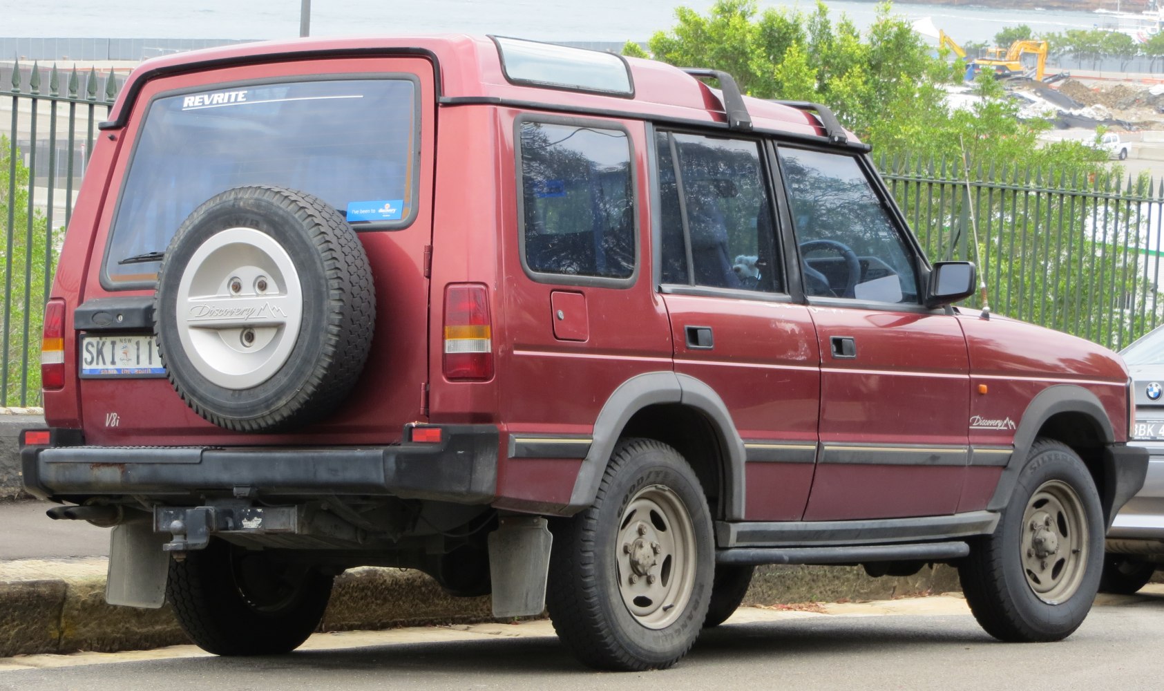Boxy SUV with roof-mounted spare tire and rear side view