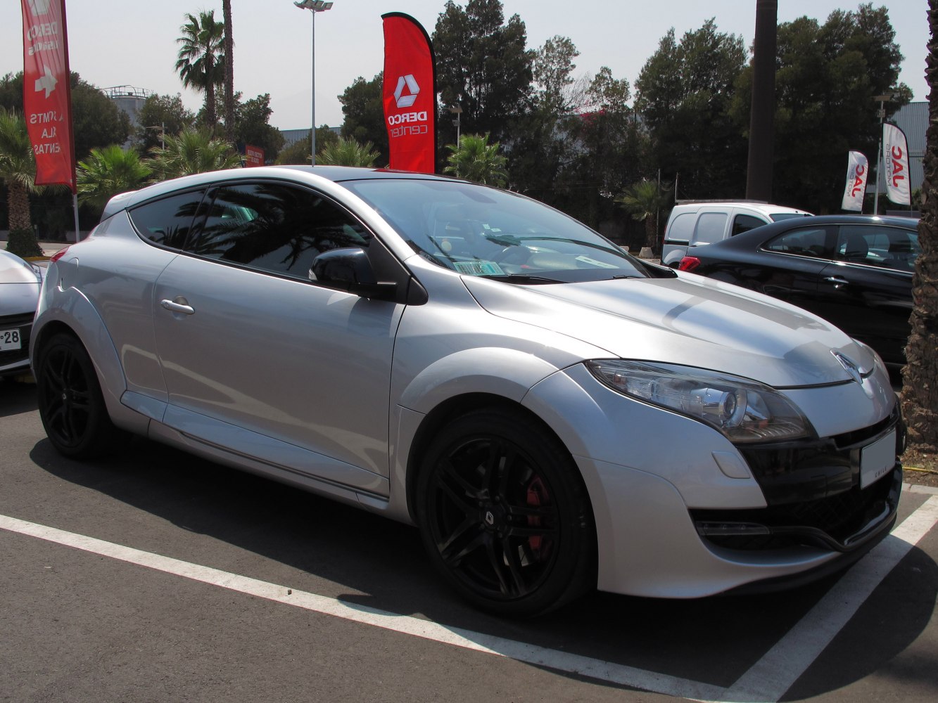 Silver coupe with black alloy wheels in side view