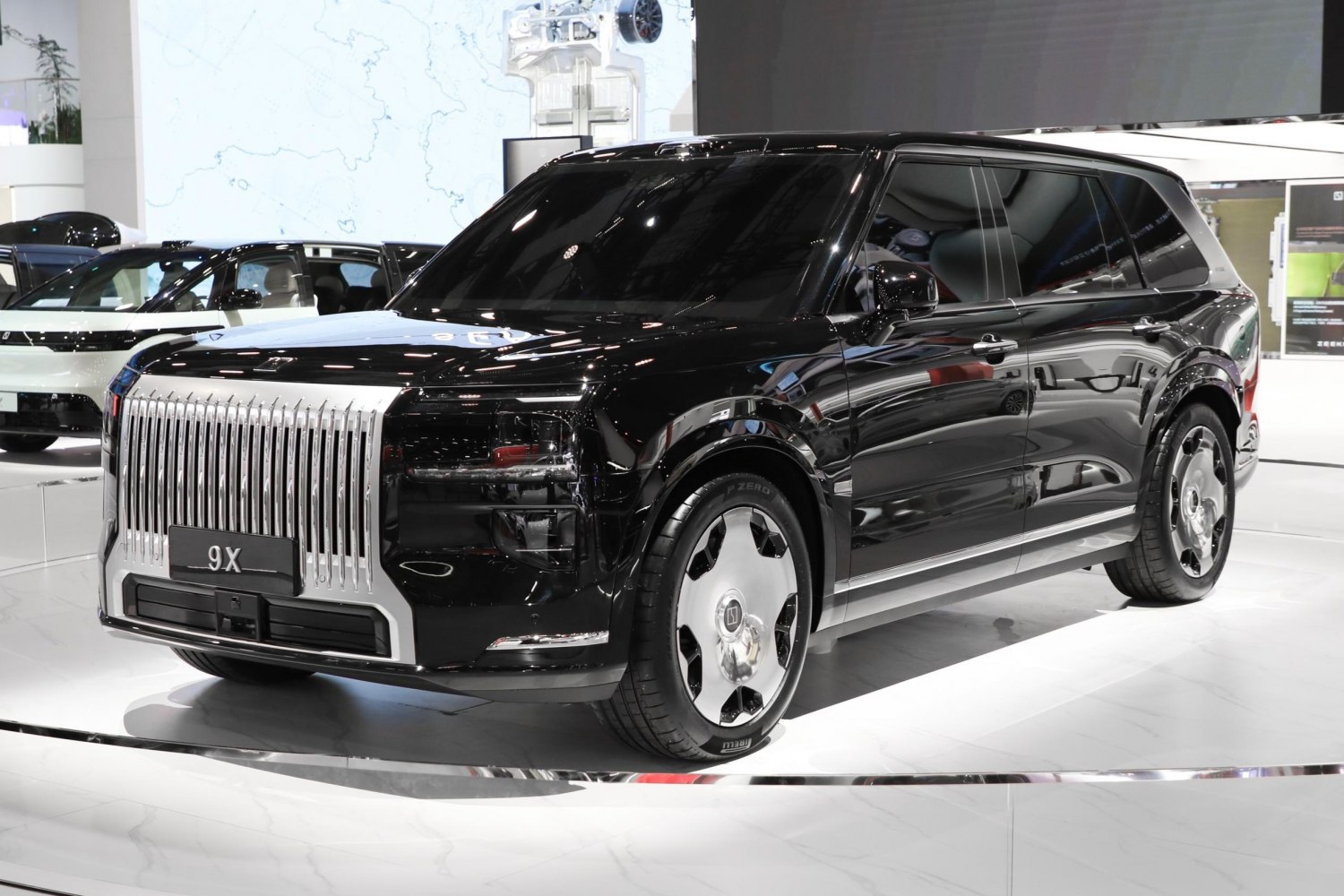 Glossy black luxury SUV with striking vertical grille and aerodynamic shape