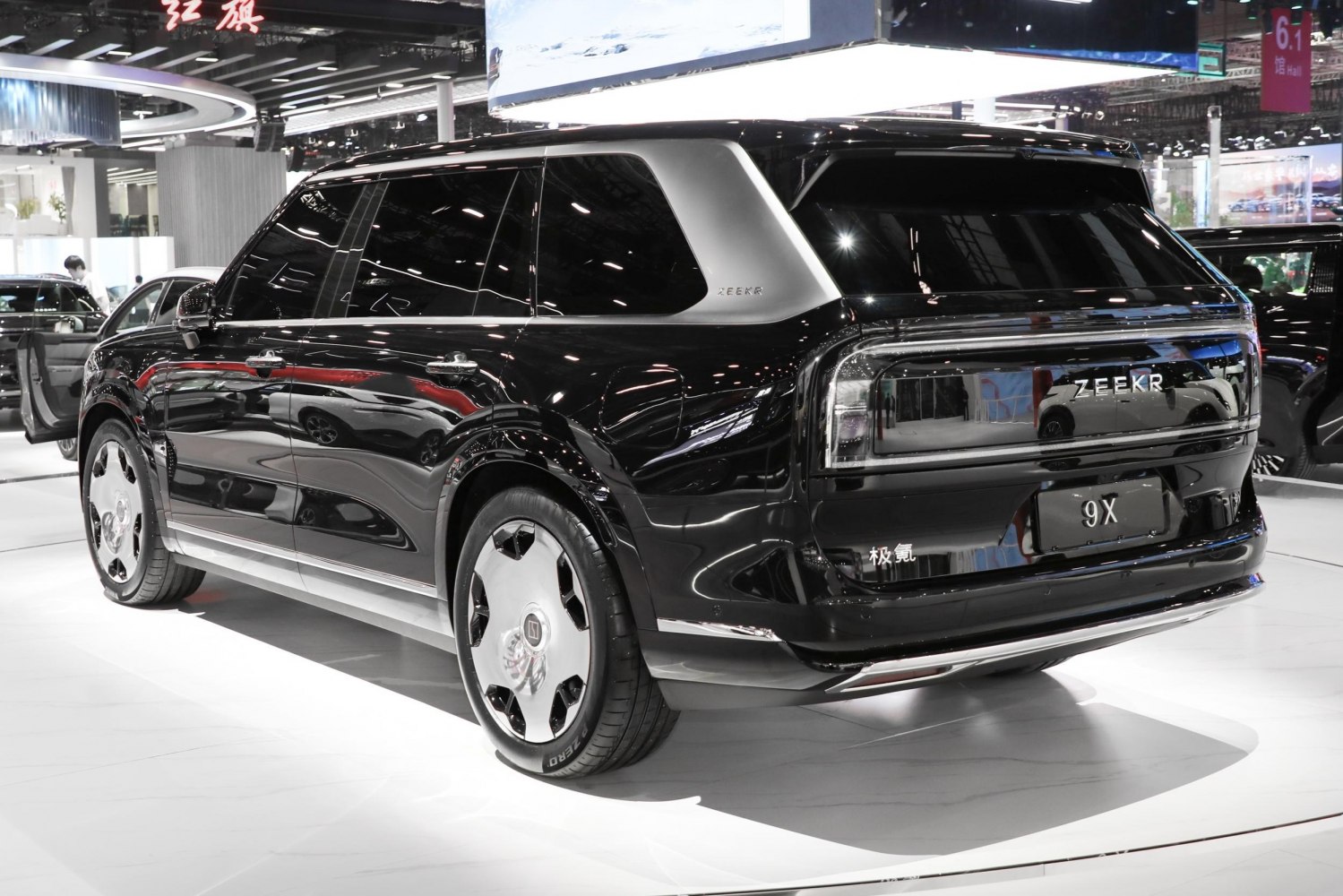 Rear and side view of a sleek black SUV with futuristic rear lighting