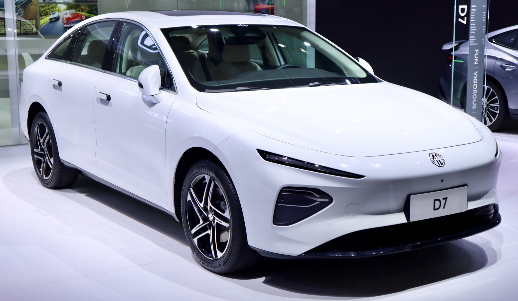 Front and side view of a sedan with slim LED headlights and alloy wheels