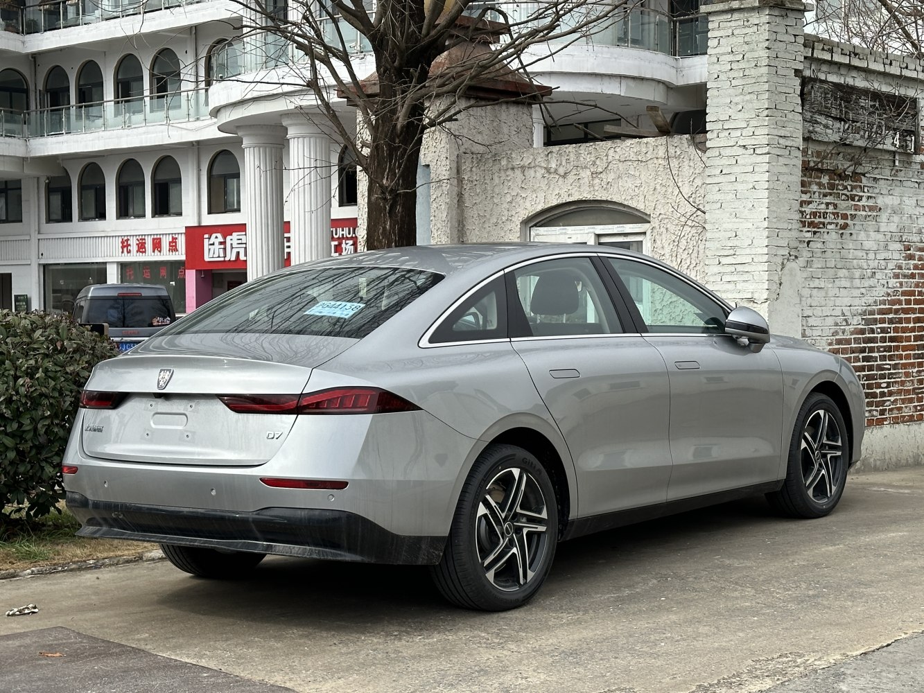 Sleek silver sedan rear side view with modern taillights and alloy wheels