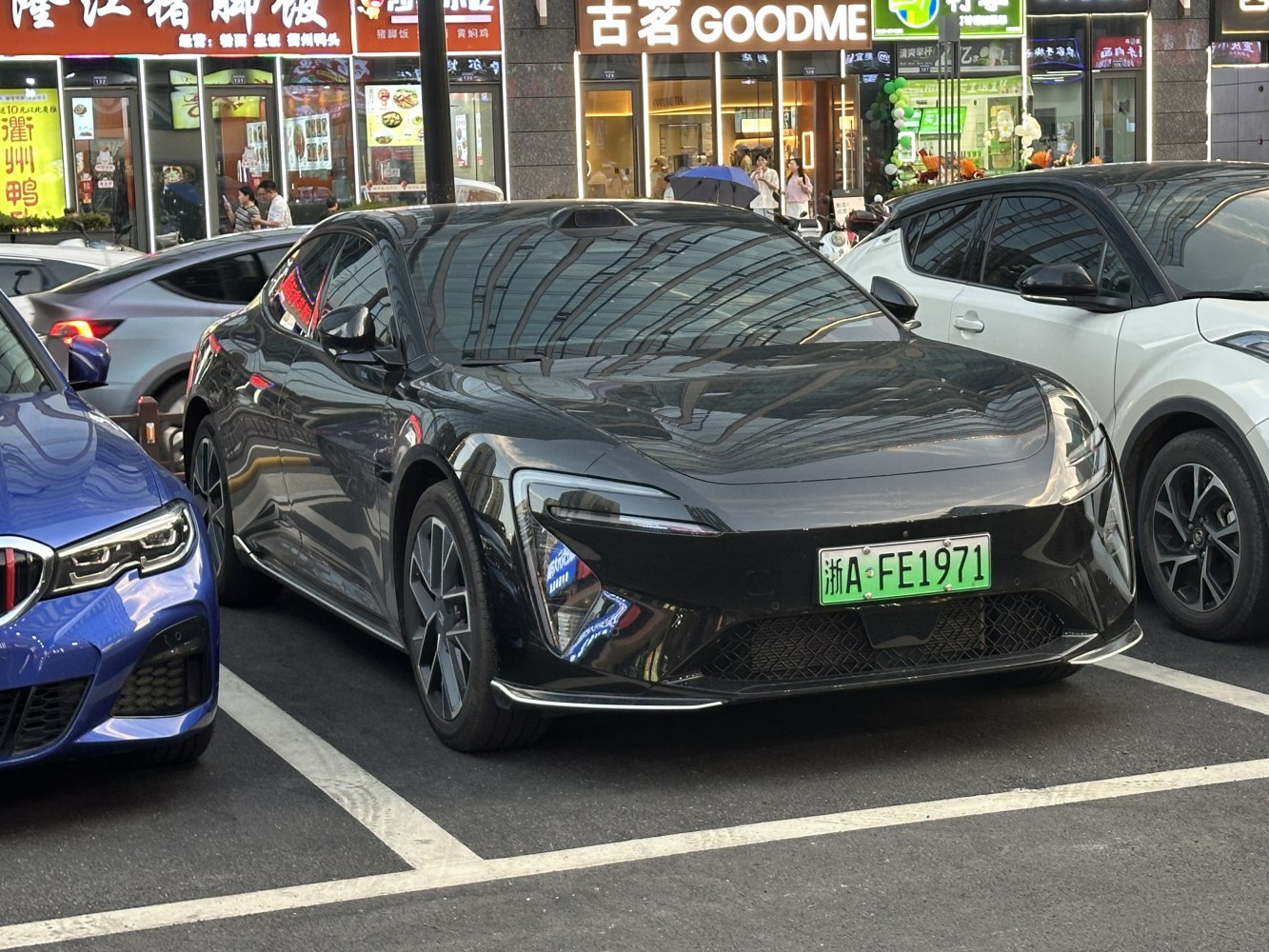 Front view of sleek electric vehicle with futuristic headlights and aerodynamic design
