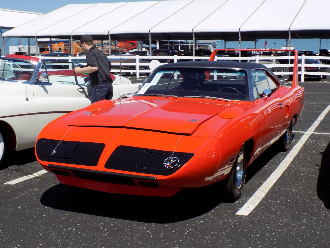 Bright orange muscle car with aerodynamic front and large rear wing