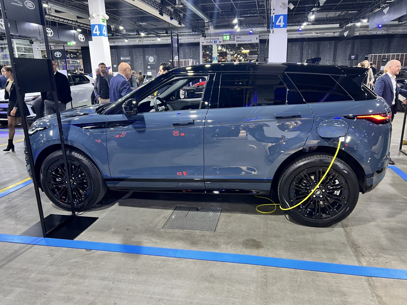 Electric SUV side charging with black wheels
