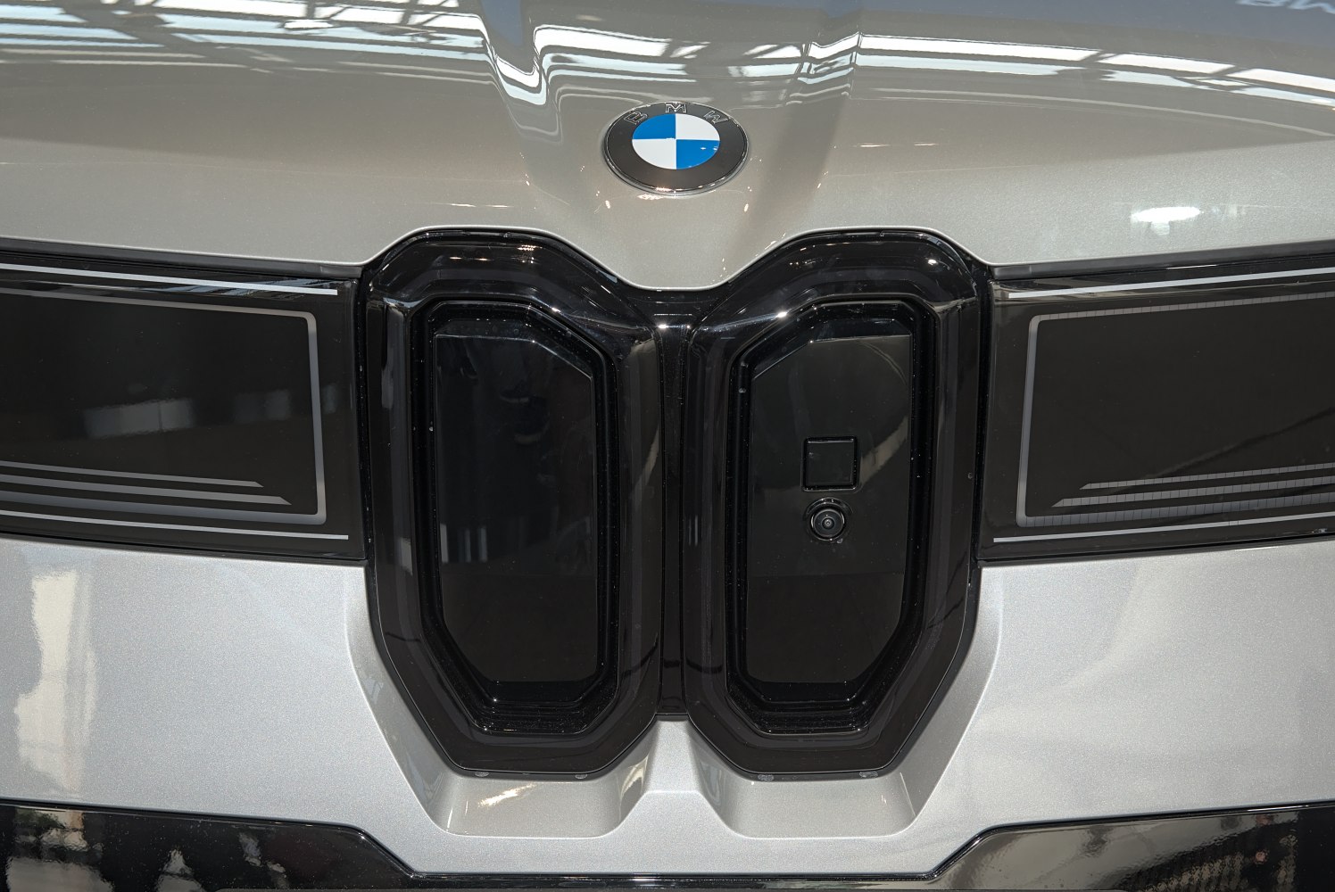 Front grille and BMW emblem close-up on electric vehicle