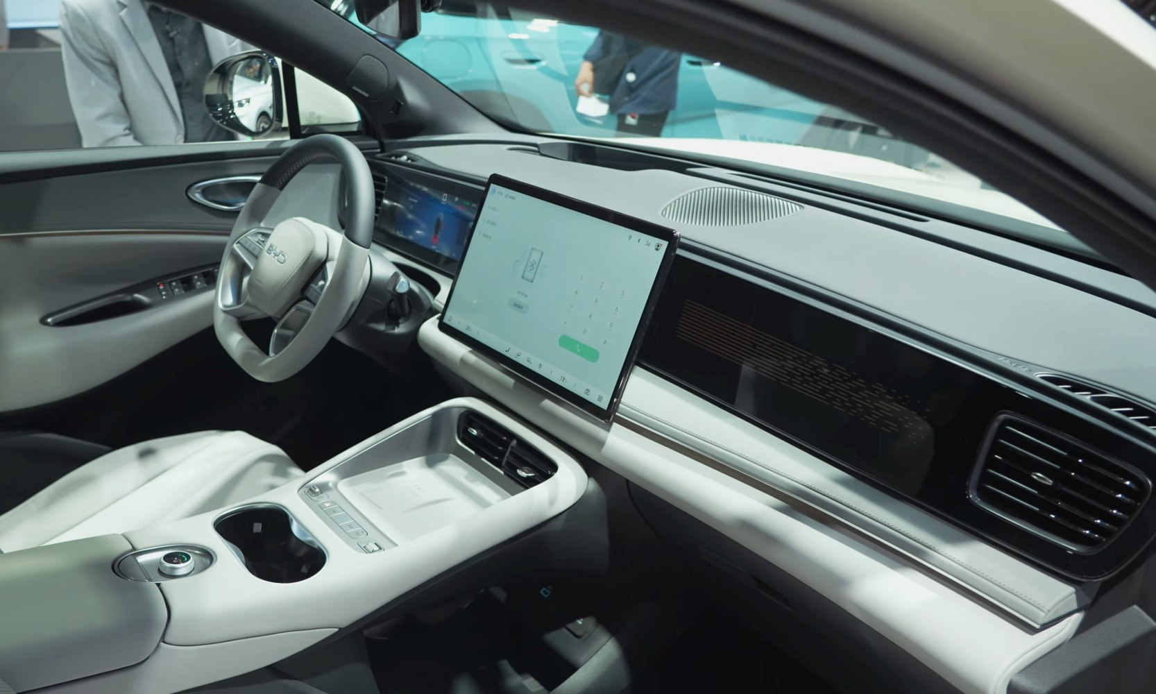 Modern car interior with large central touchscreen and sleek dashboard.