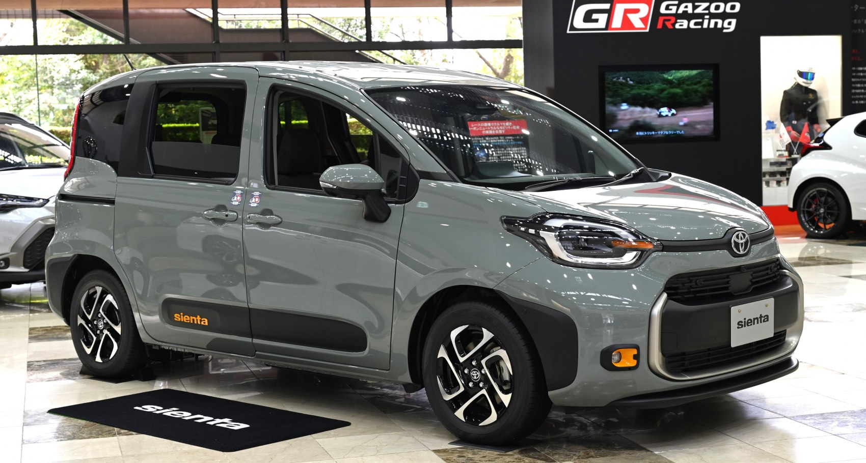 Compact multi-purpose vehicle with sliding rear doors and modern headlight design.