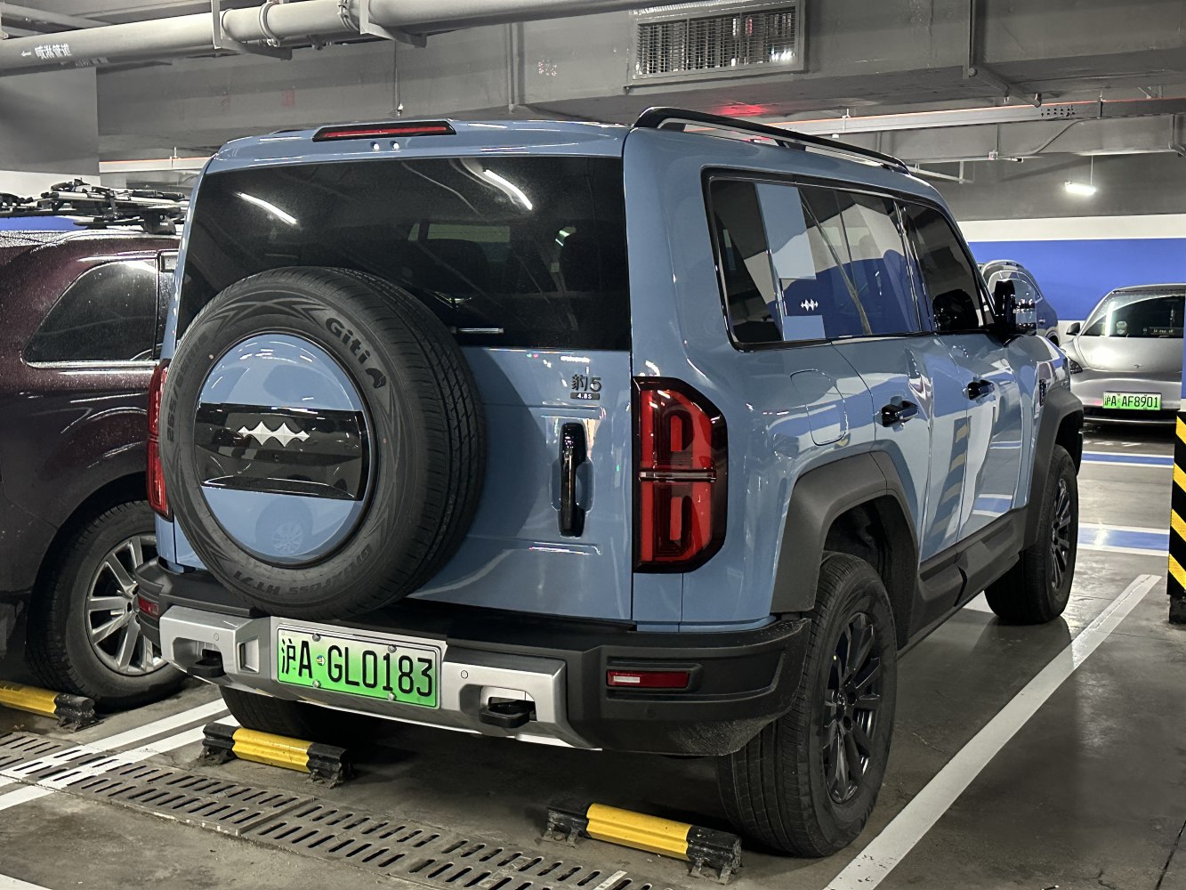 Rear view of SUV with rear-mounted spare tire and distinctive taillights
