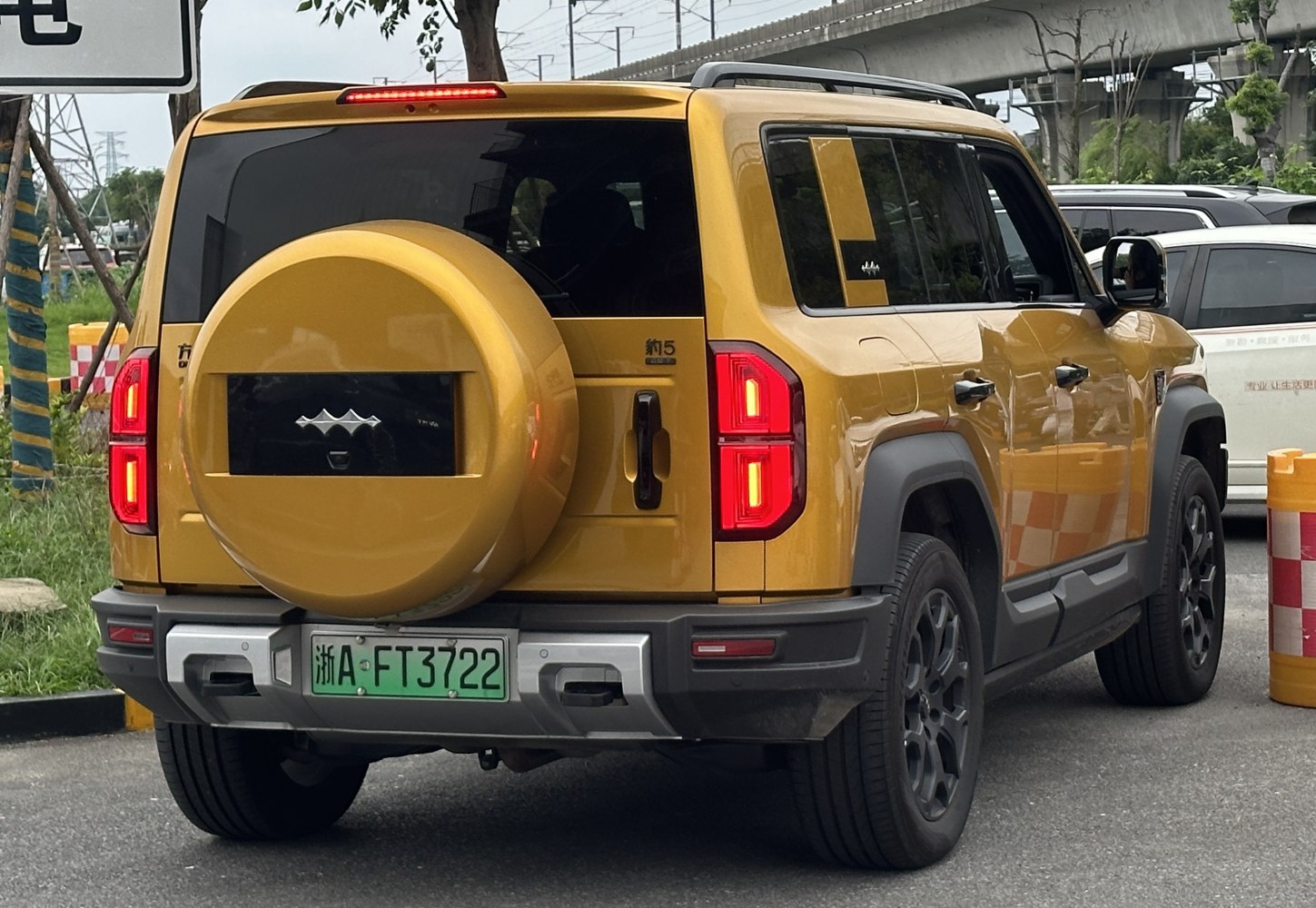 Rear view of SUV with spare tire cover and distinct taillights