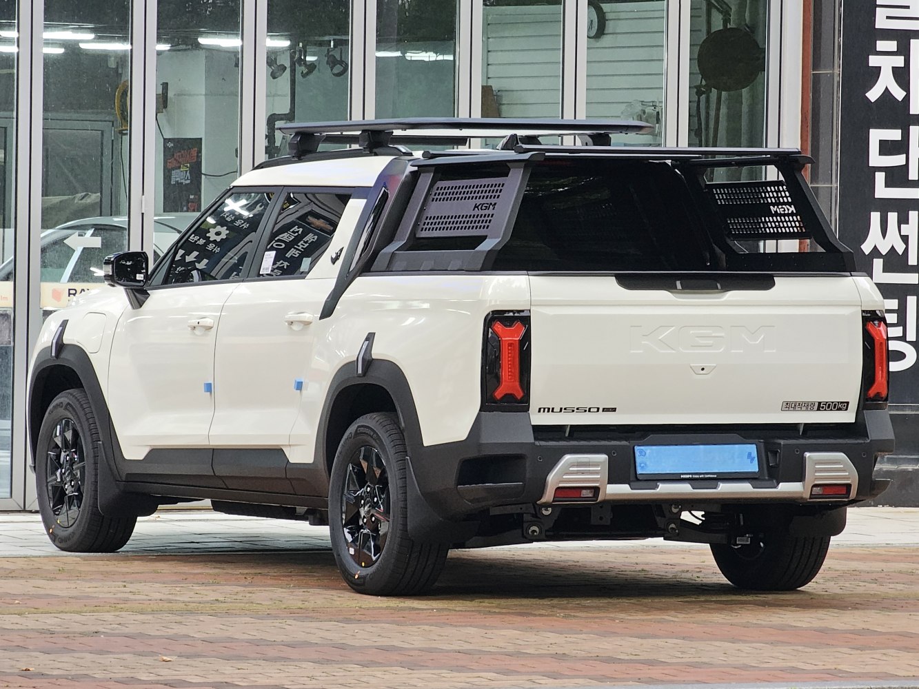 Pickup truck with unique rear tailgate, vertical taillights, and a roof rack