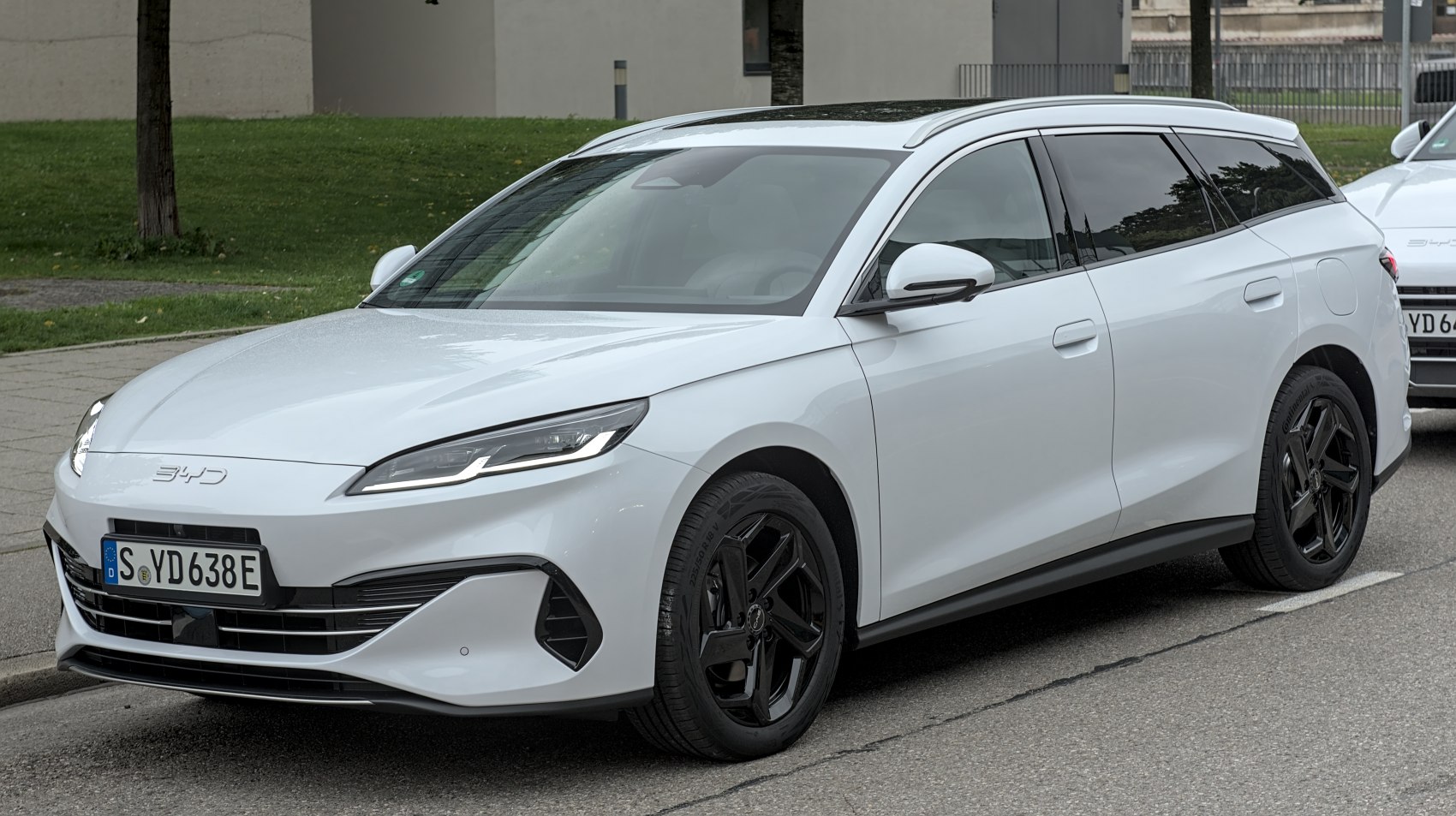 White sleek aerodynamic vehicle with black rims, front-side angle