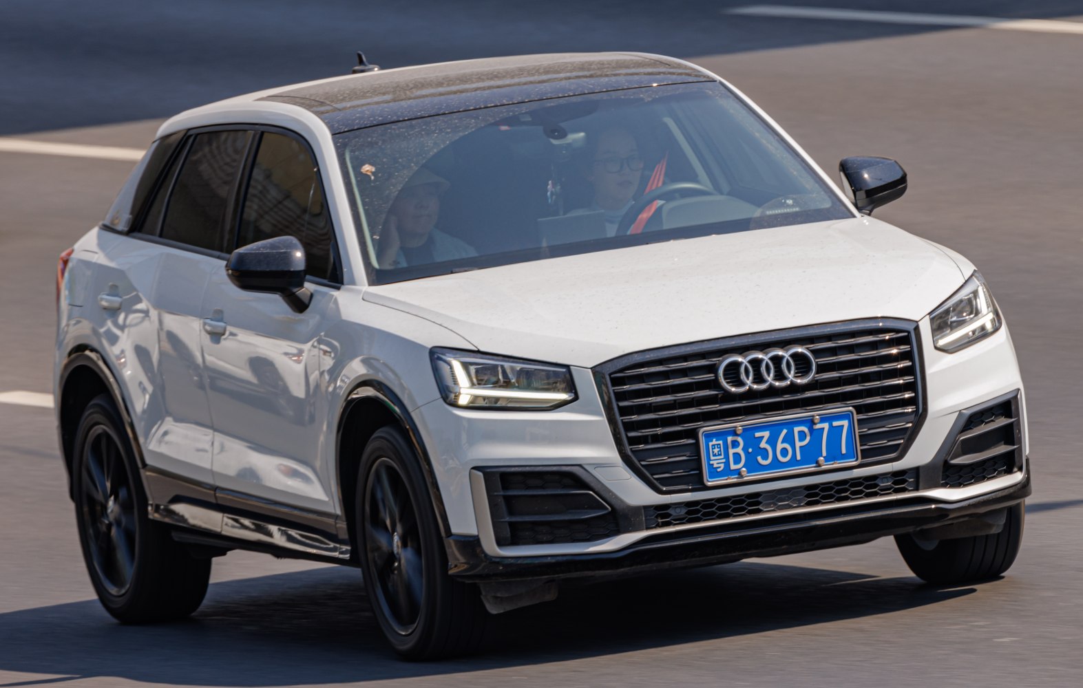 White SUV front with LED headlights and large black grille