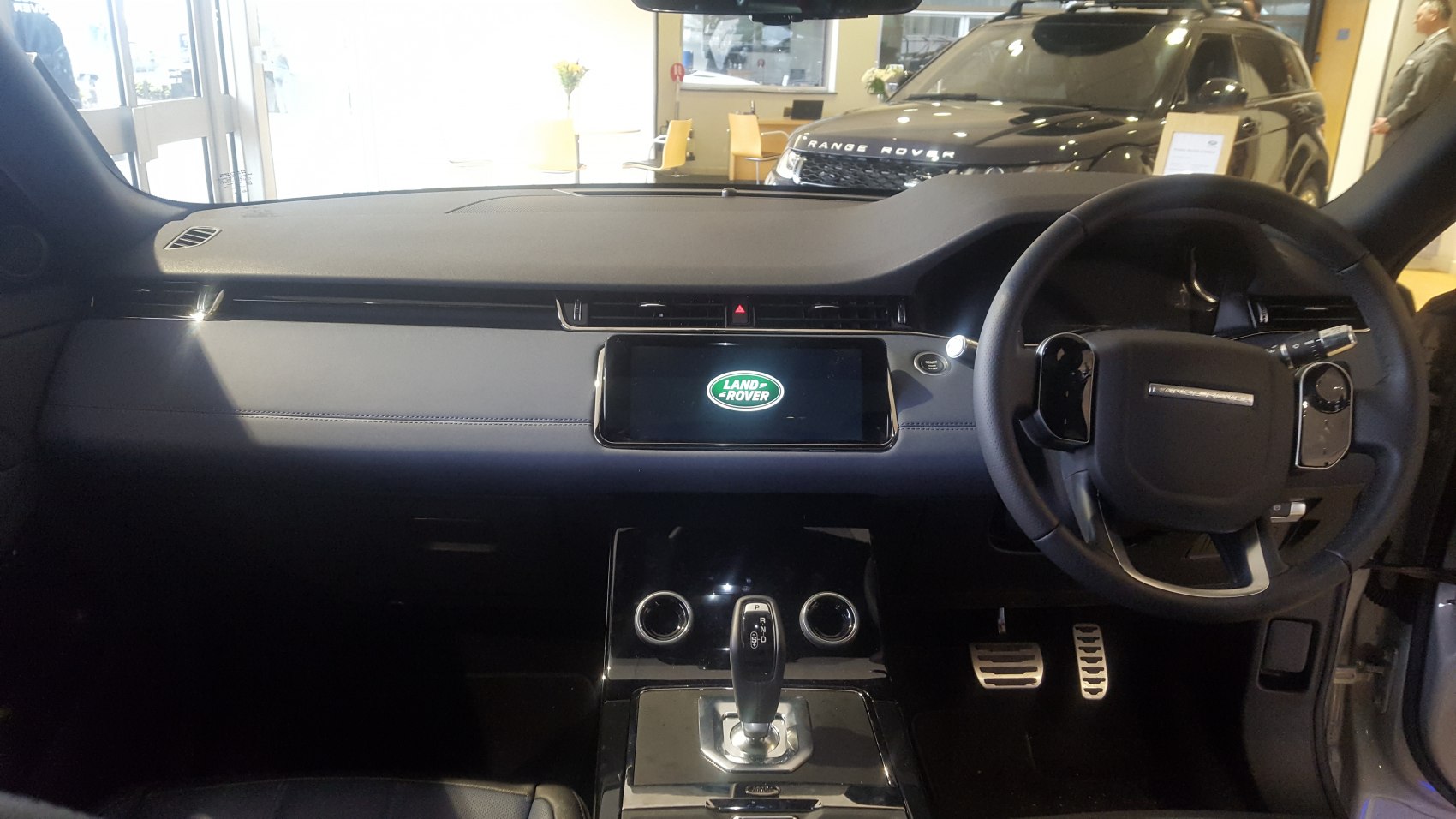 Modern dashboard and steering wheel with central infotainment screen and gear shift