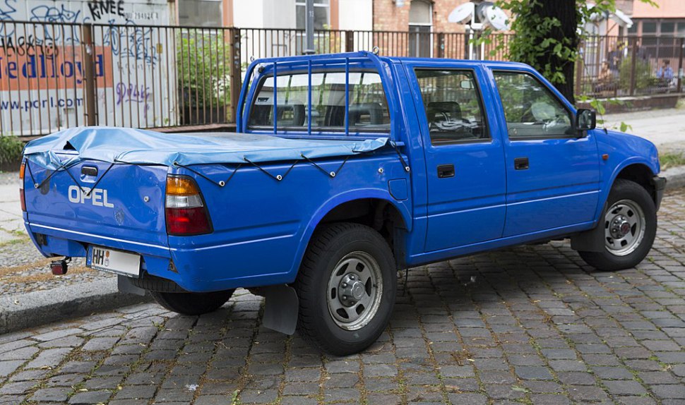 Blue double cab pickup with covered bed and rear protection bars