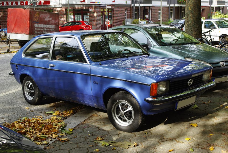 Blue vintage hatchback with side profile and classic design.