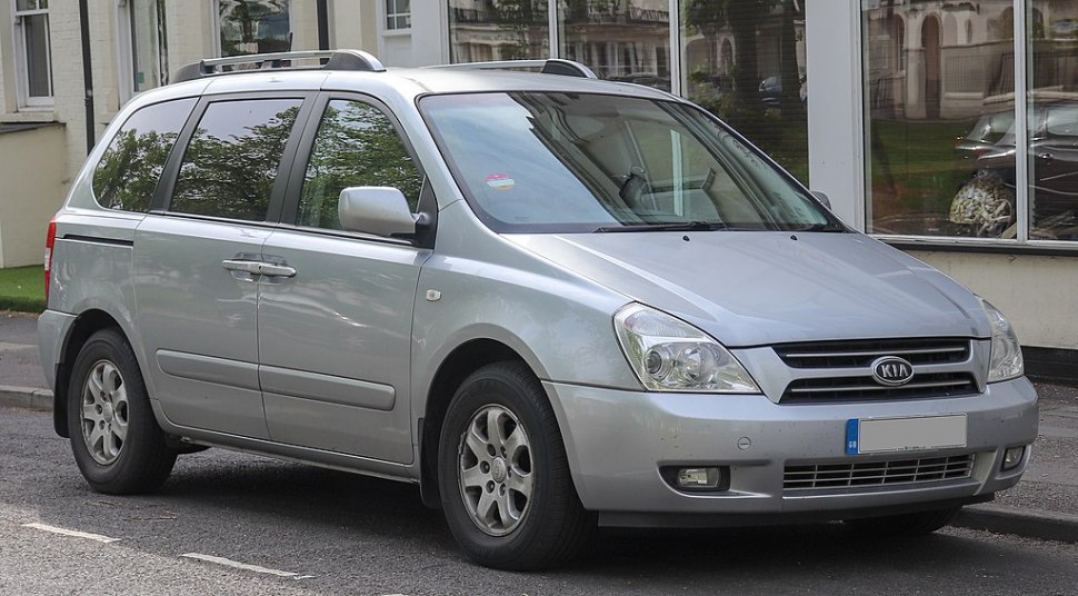 Silver minivan front side view with headlamp and grille details
